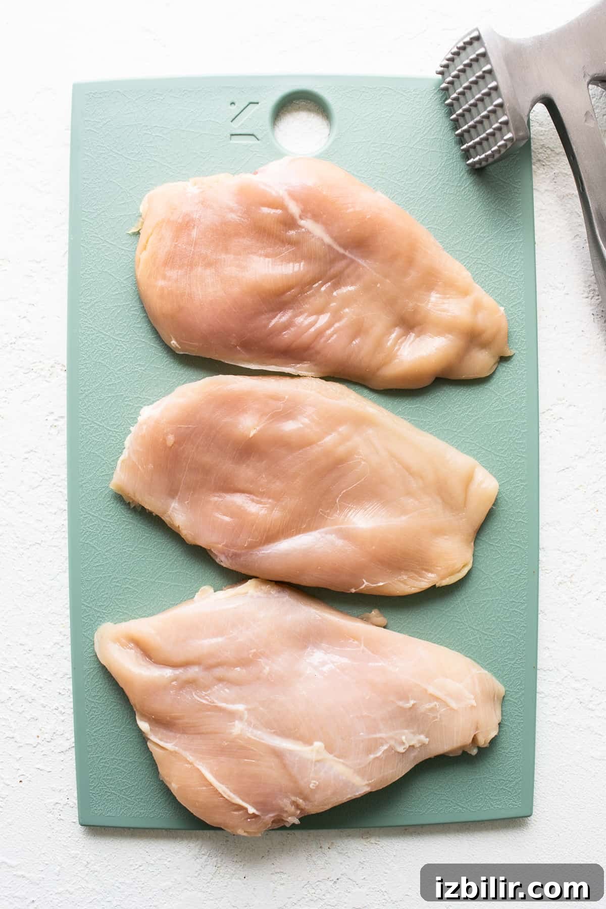 How to Grill Juicy Chicken Every Time 3 chicken breast on cutting board.