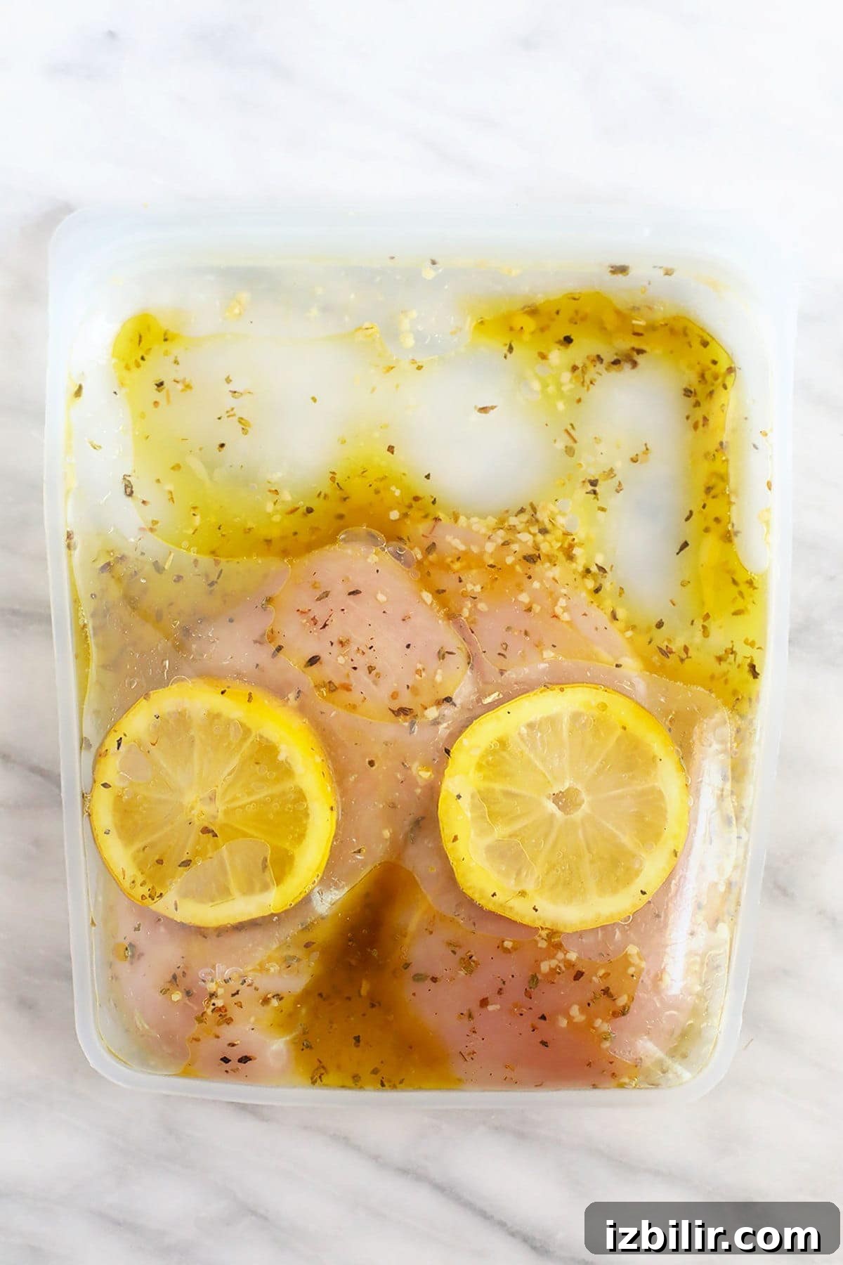 Greek Chicken Marinade with Lemon and Oregano 6 chicken marinating in bag with lemon