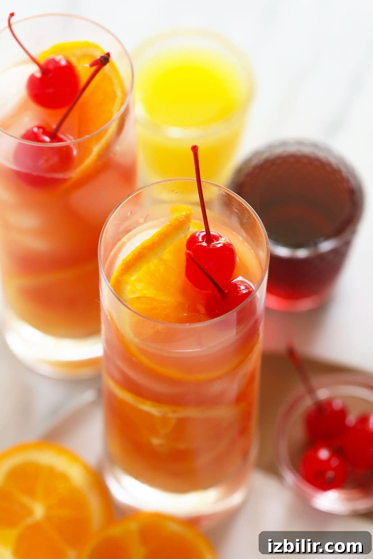 Sex on the beach cocktails with cherries and oranges.