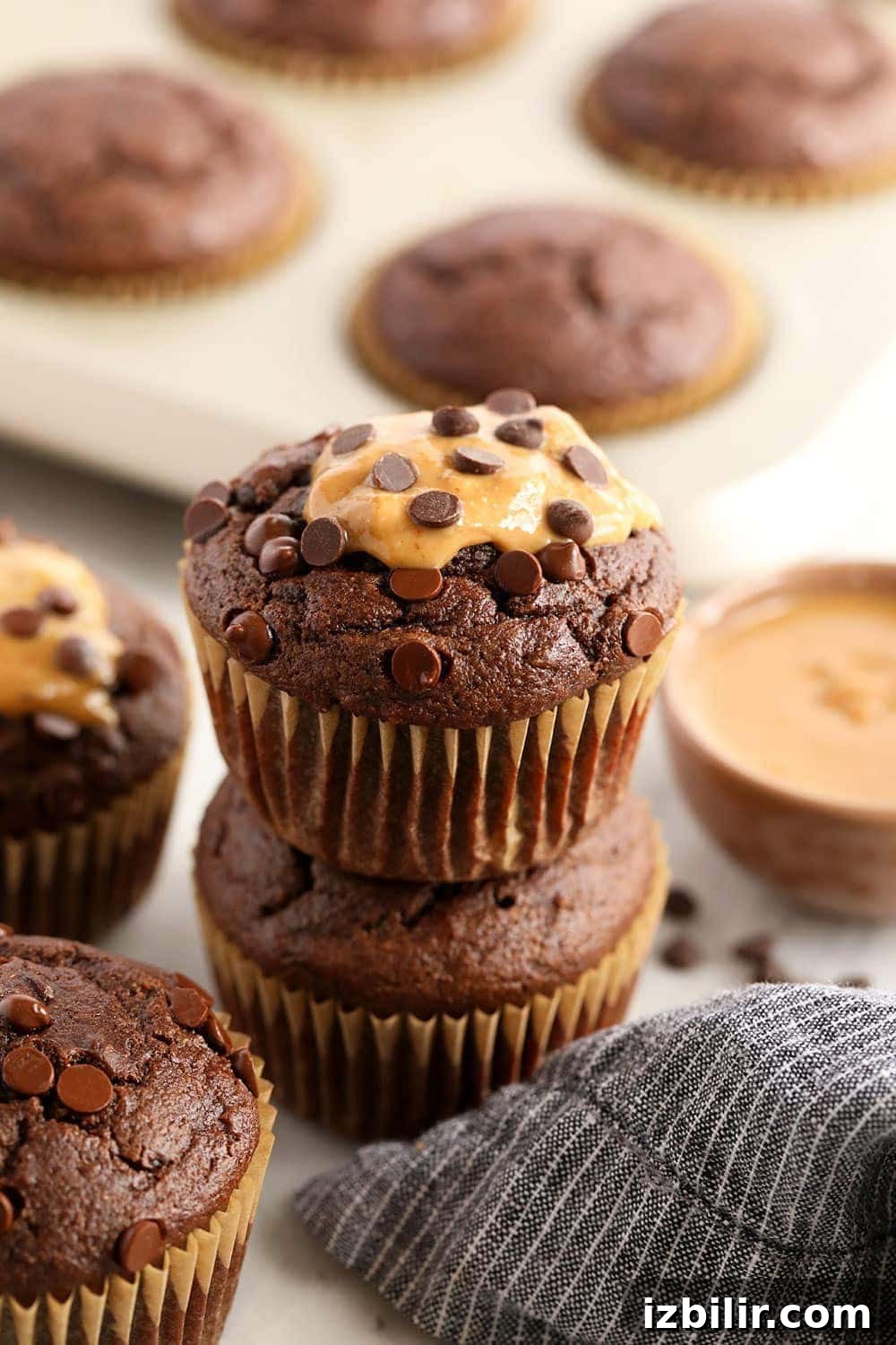 healthy chocolate peanut butter muffins stacked