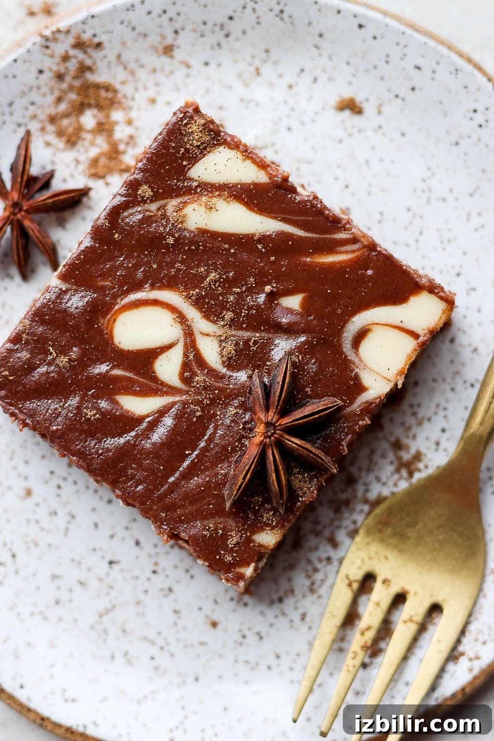 A chocolate chai cheesecake bar on a plate.
