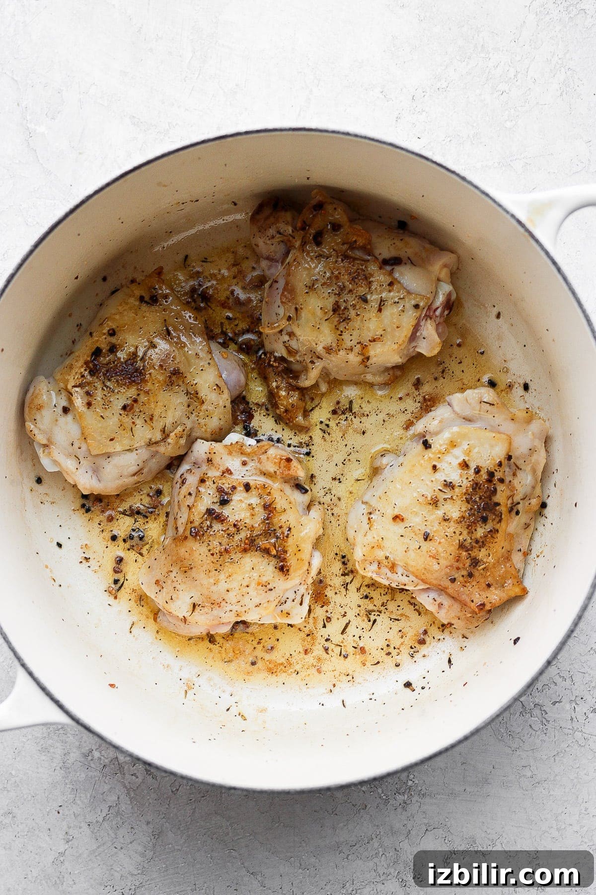 A flavorful chicken and rice recipe made with juicy chicken thighs and the most flavorful rice medley you've ever had! And, yes, it includes tons of veggies! sautéed chicken thighs in Dutch oven.