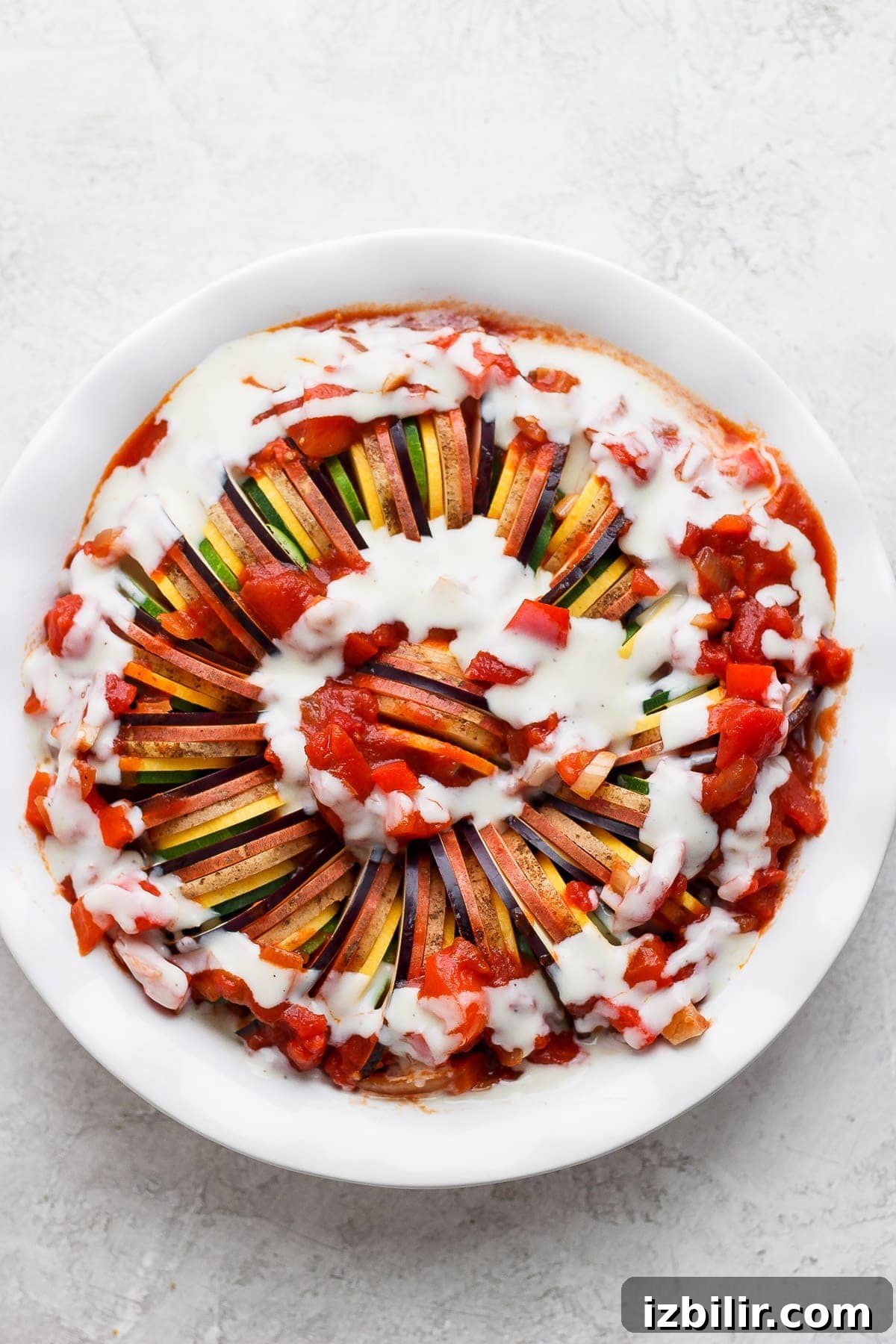 Authentic French Ratatouille Recipe 6 Ratatouille with vegetables and sauce poured over the top.