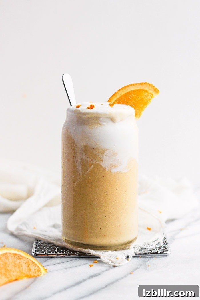 All you need are 4 simple ingredients to make this delicious and creamy Orange Creamsicle Smoothie that is packed with Vitamin C and flavor! Orange smoothie with fresh orange slice
