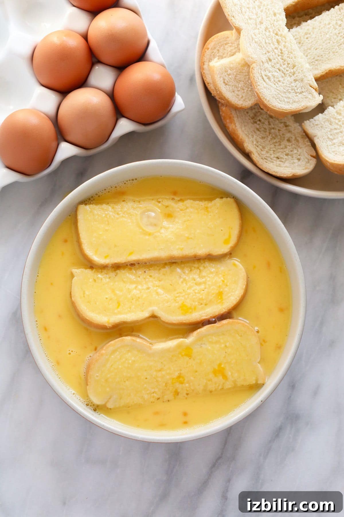 Soaking French toast sticks in egg wash