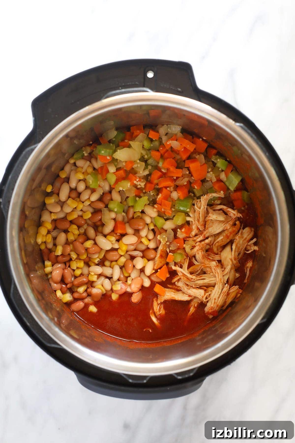Instant Pot Buffalo Chicken Chili in progress. chili ingredients in instant pot