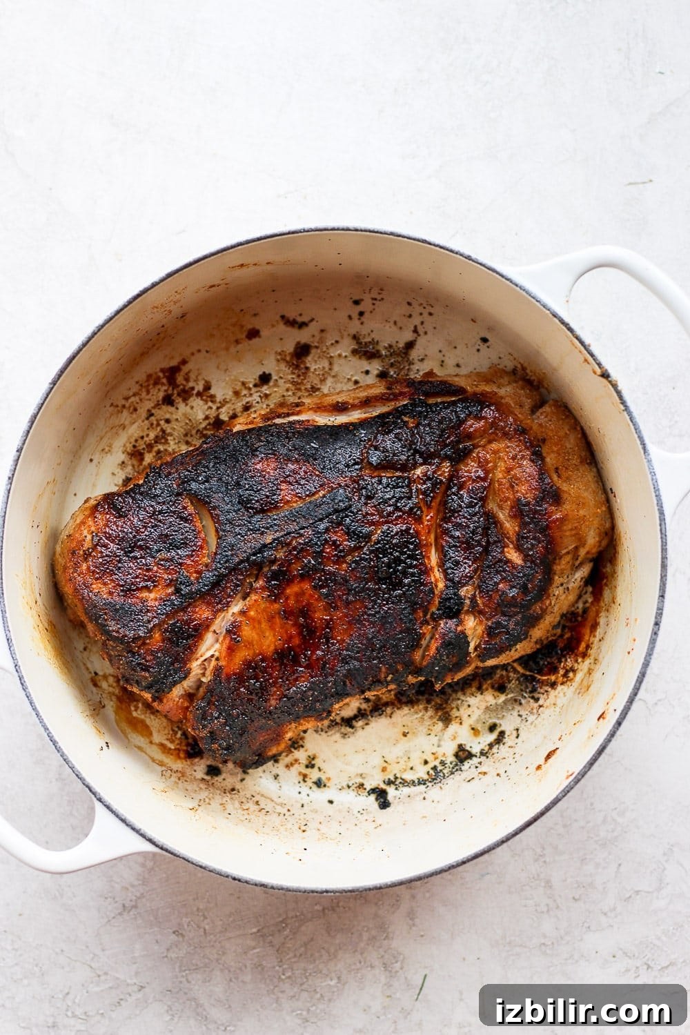 seared pork shoulder in a stock pot