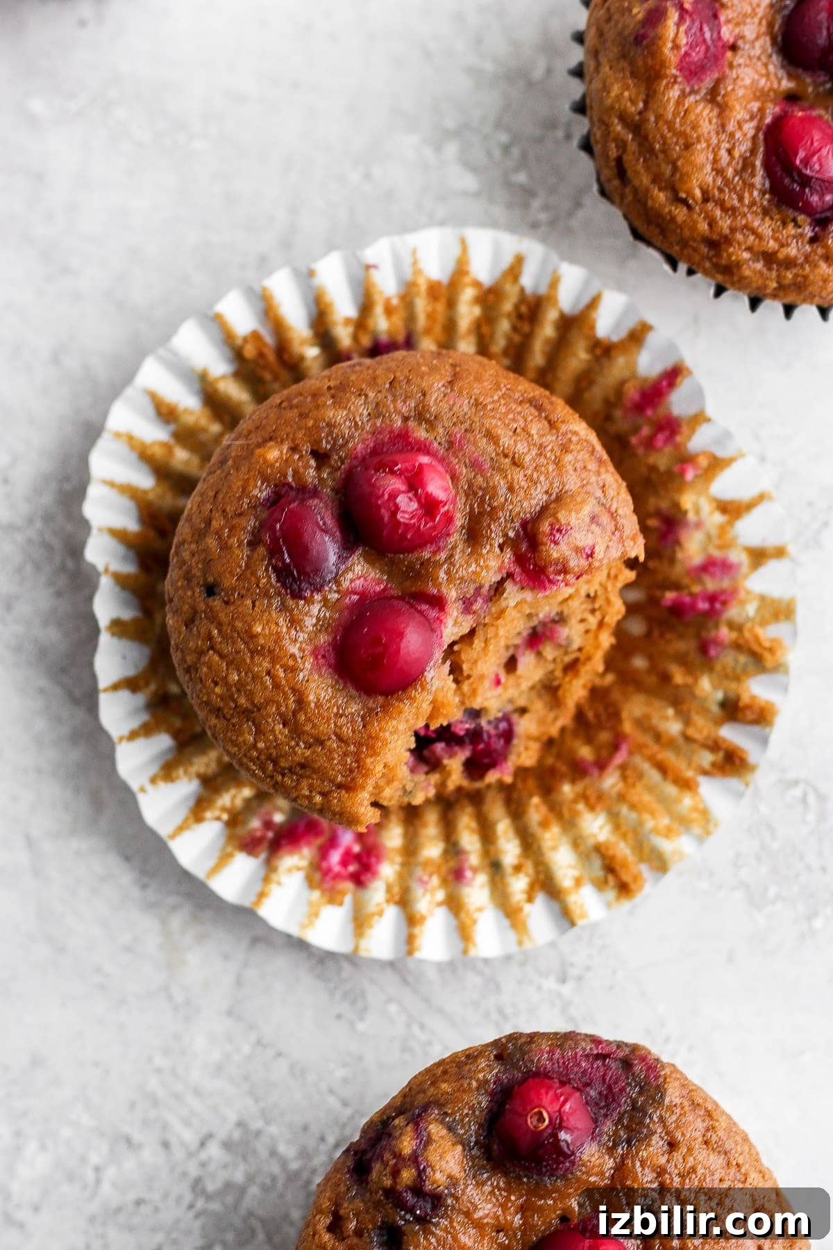 cranberry orange muffin in a muffin liner