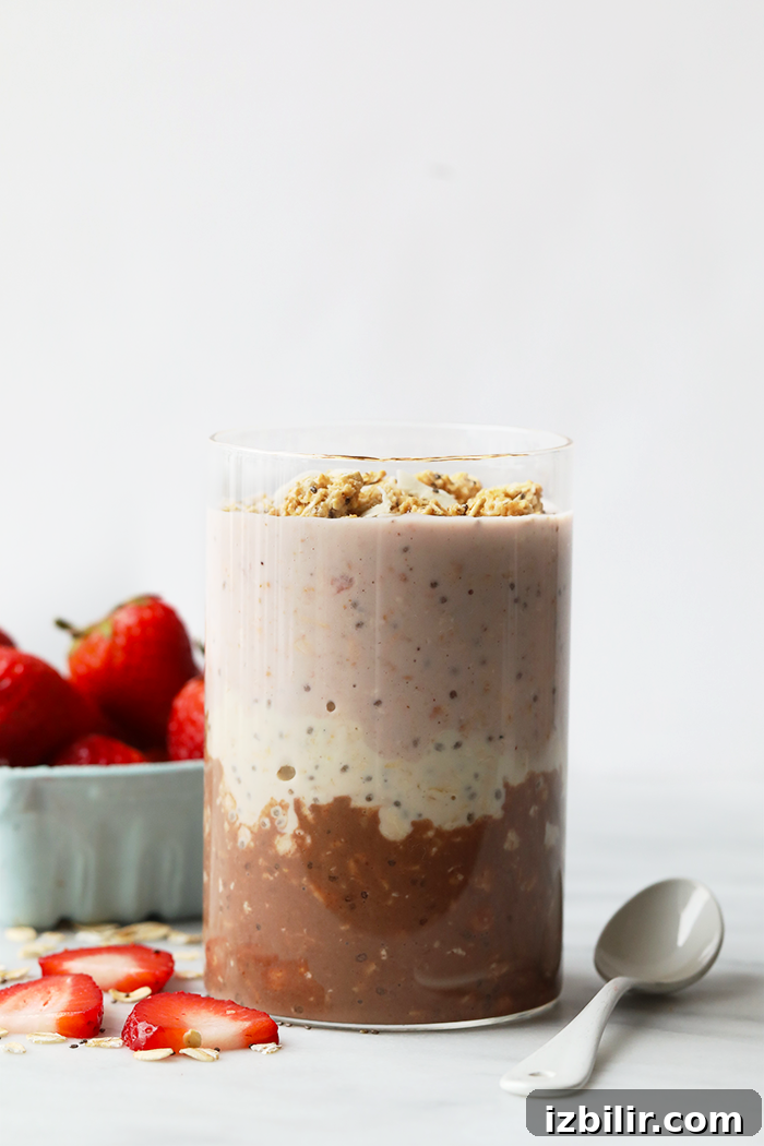 Neapolitan Overnight Oats: Chocolate, Vanilla & Strawberry 2 Neapolitan overnight oats served in a glass jar.