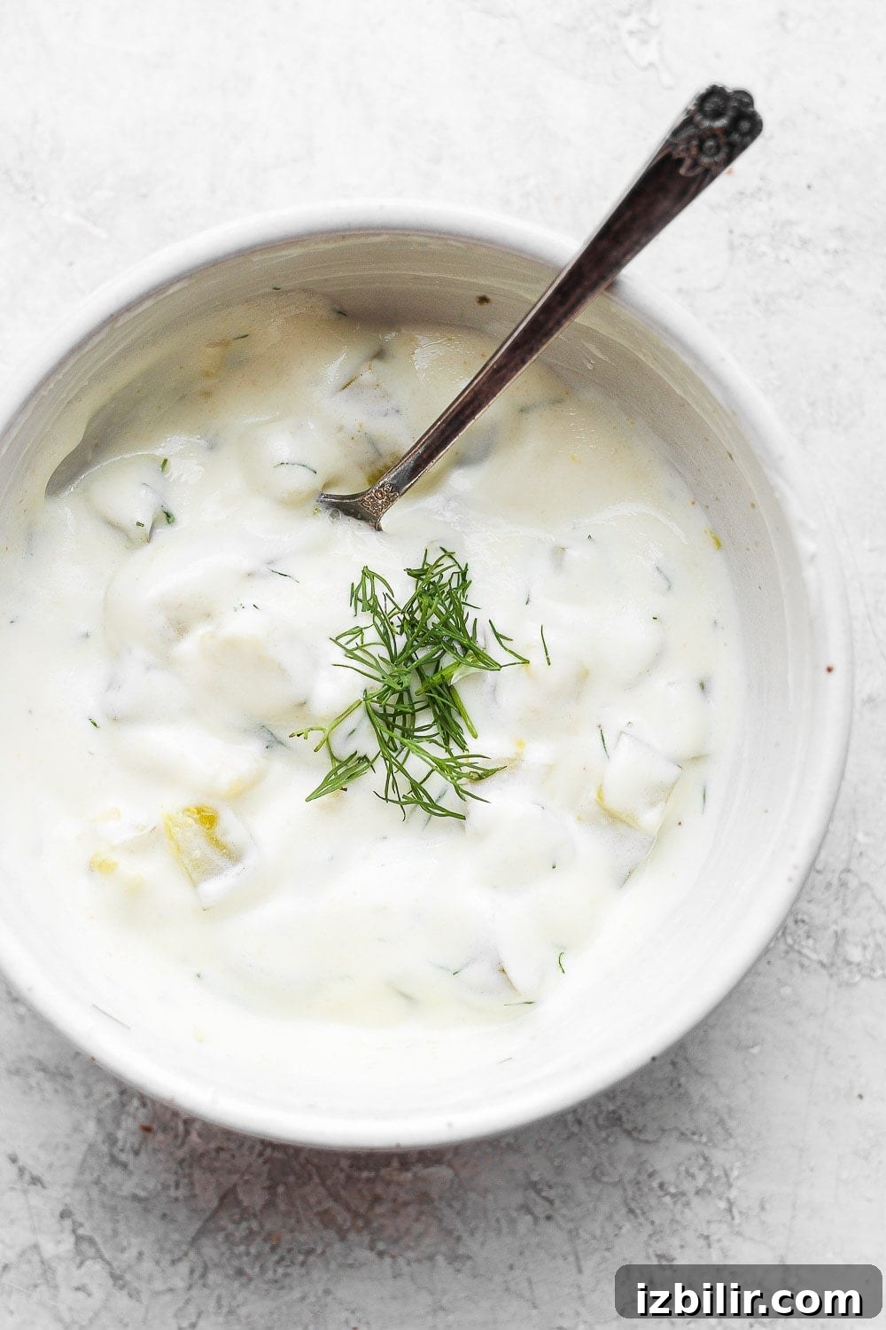 dill pickle dip in bowl with spoon