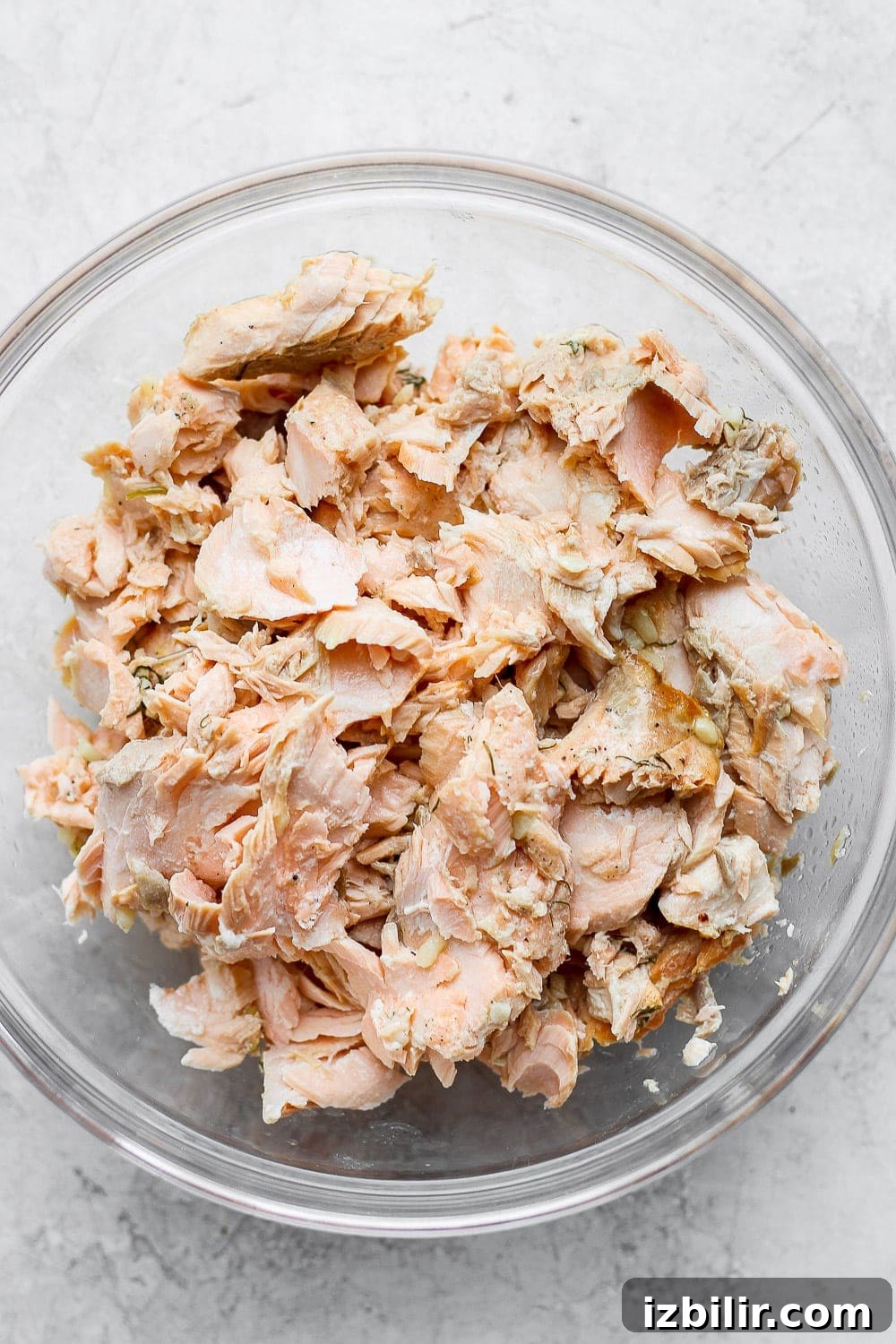 Flaked salmon in a bowl, ready for patties flaked salmon in a bowl