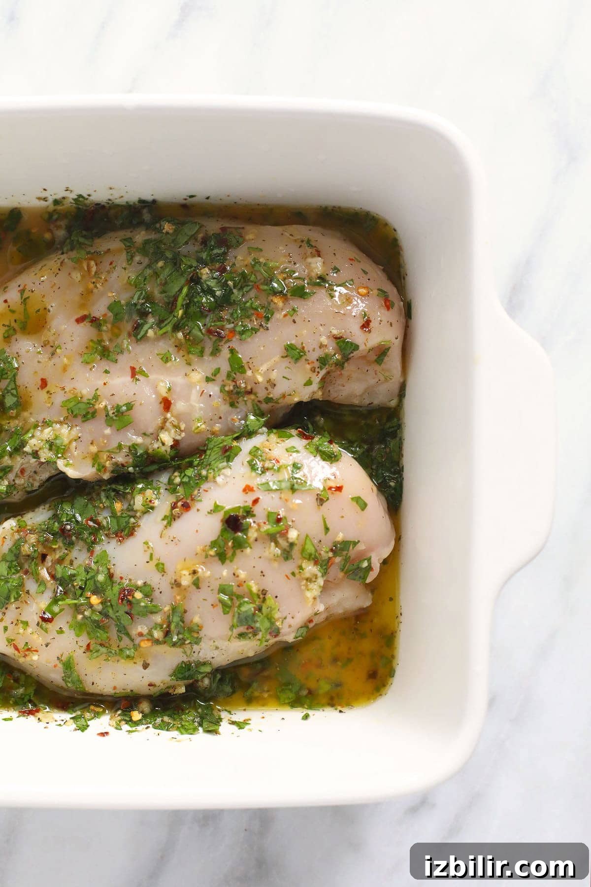 Homemade Italian dressing chicken marinade chicken marinating in dish.