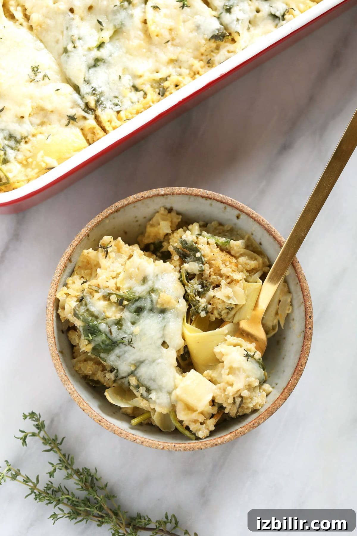 There are potatoes, spinach, artichokes, quinoa, and a delicious sauce in this quinoa casserole!