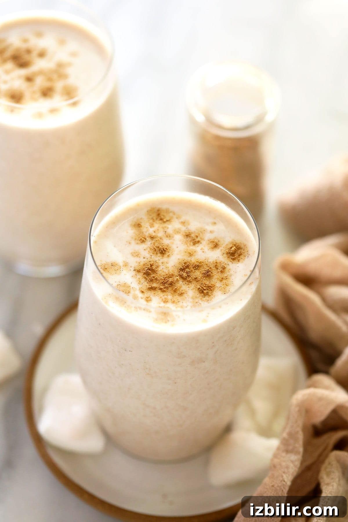 Coconut chai protein shakes in two glasses.