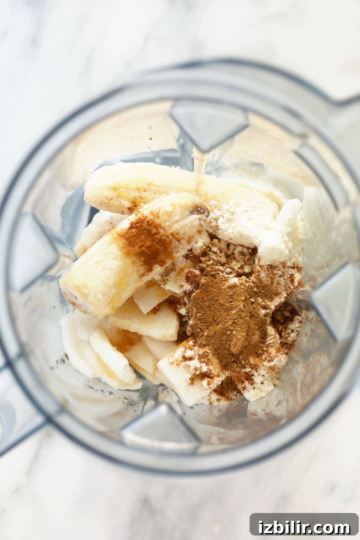 All the ingredients for the chai protein shake in a blender.