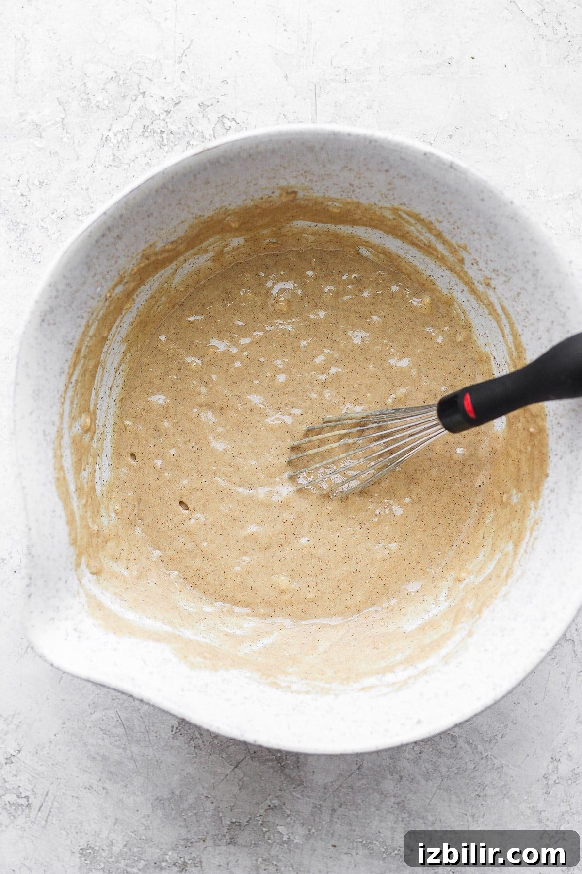 all the ingredients for cinnamon roll waffles mixed together in a bowl