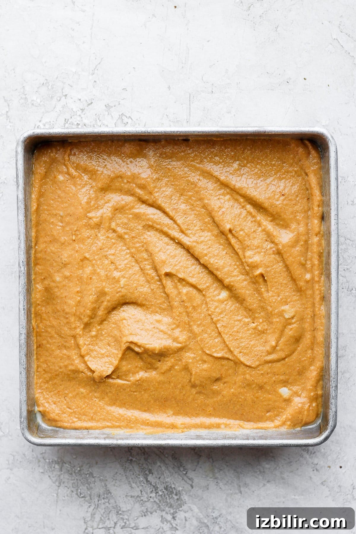 Pumpkin sheet cake batter in a pan pumpkin sheet cake batter in a square pan