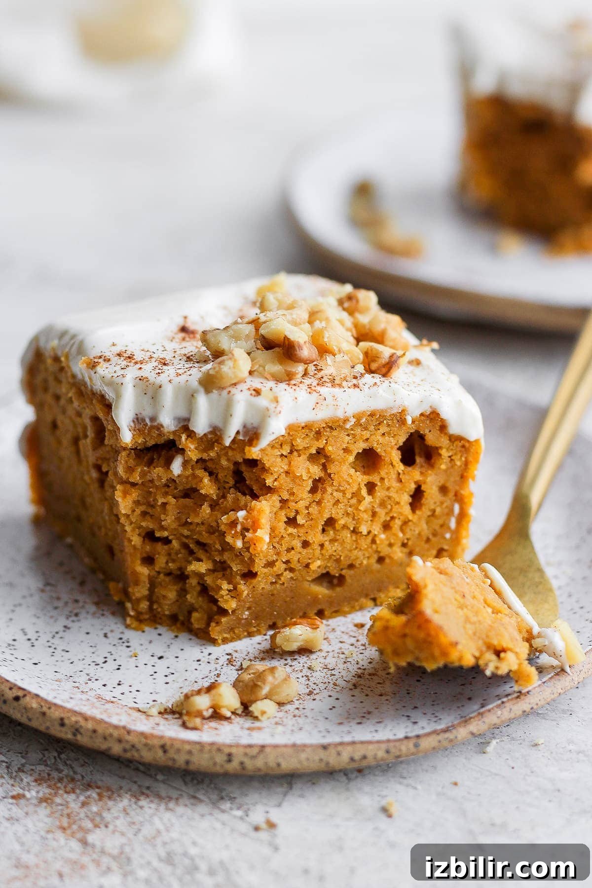 Pumpkin sheet cake ready to eat slice of pumpkin sheet cake on a plate with a bite ready to eat on a fork