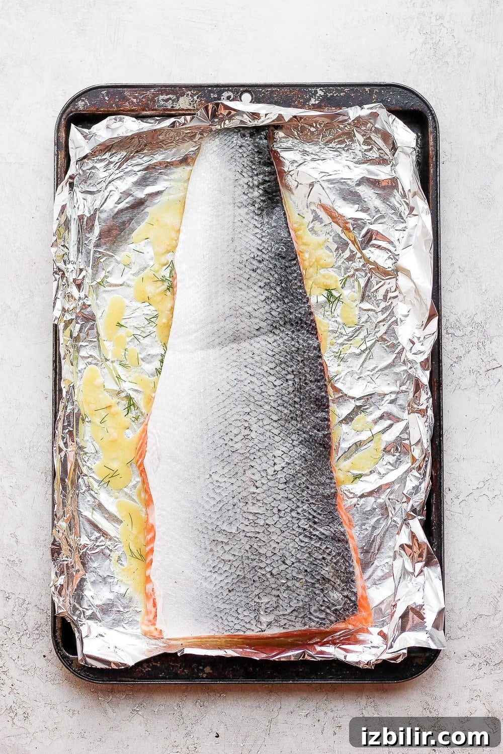 Salmon marinating in a baking sheet