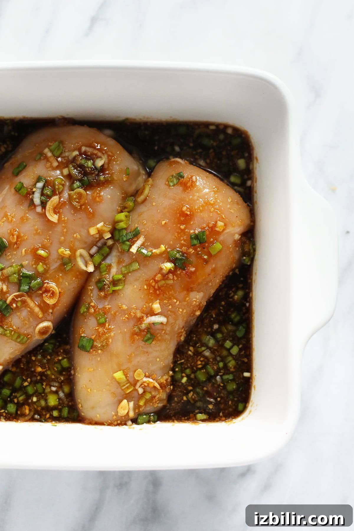 2 chicken breasts marinating in sauce