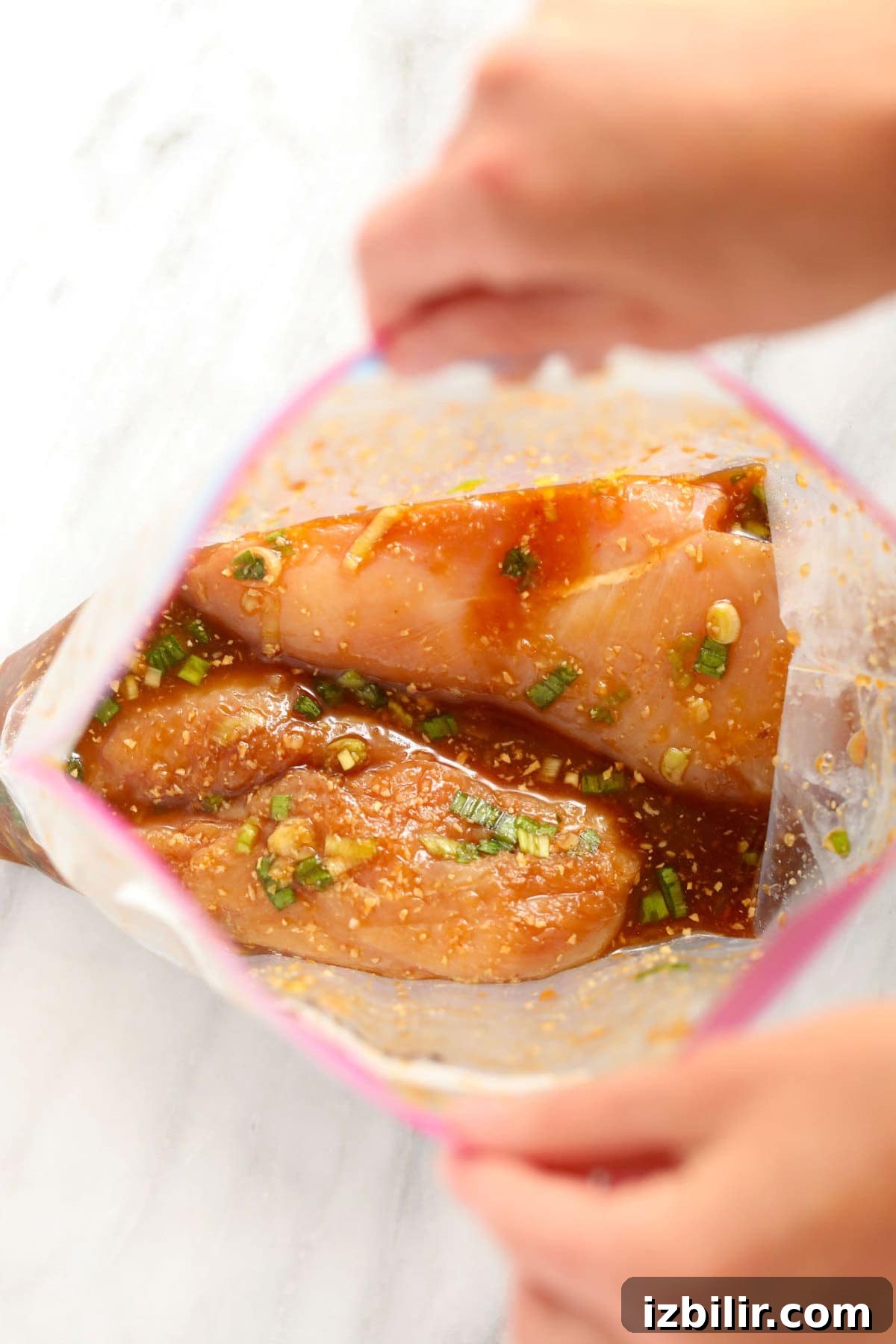 chicken marinating in plastic bag