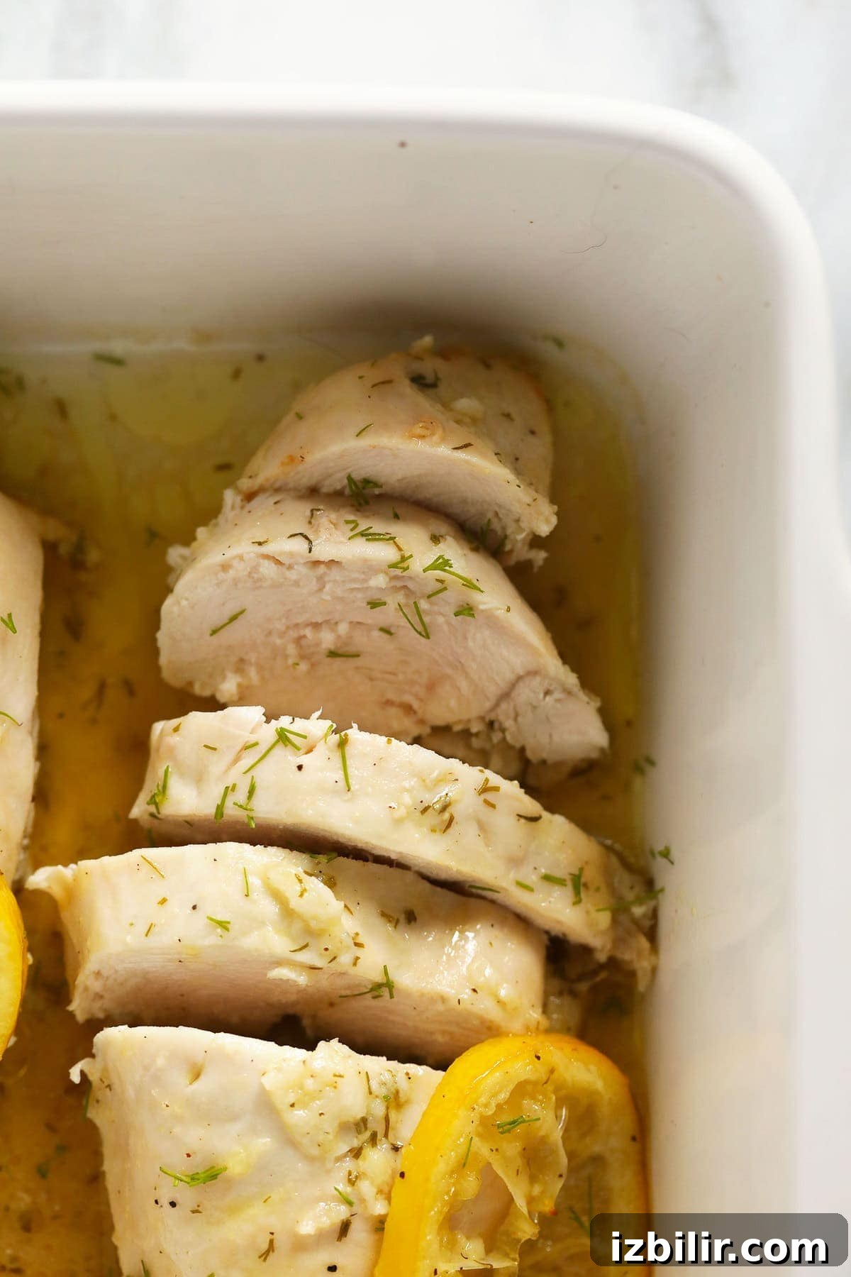 sliced lemon chicken in a baking dish