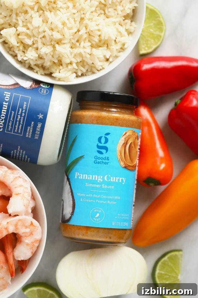 Panang curry simmer sauce, coconut oil, peppers, and shrimp on a cutting board