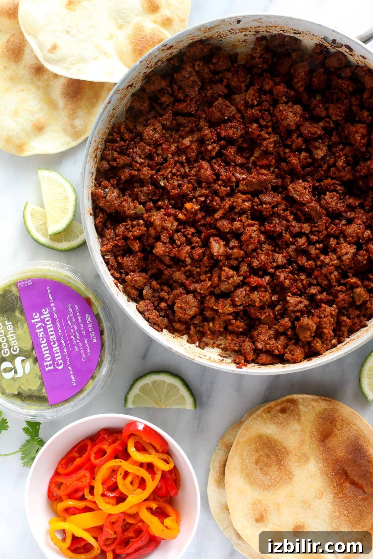 Plant-based topping with lime plant based ground with guacamole and lime wedges