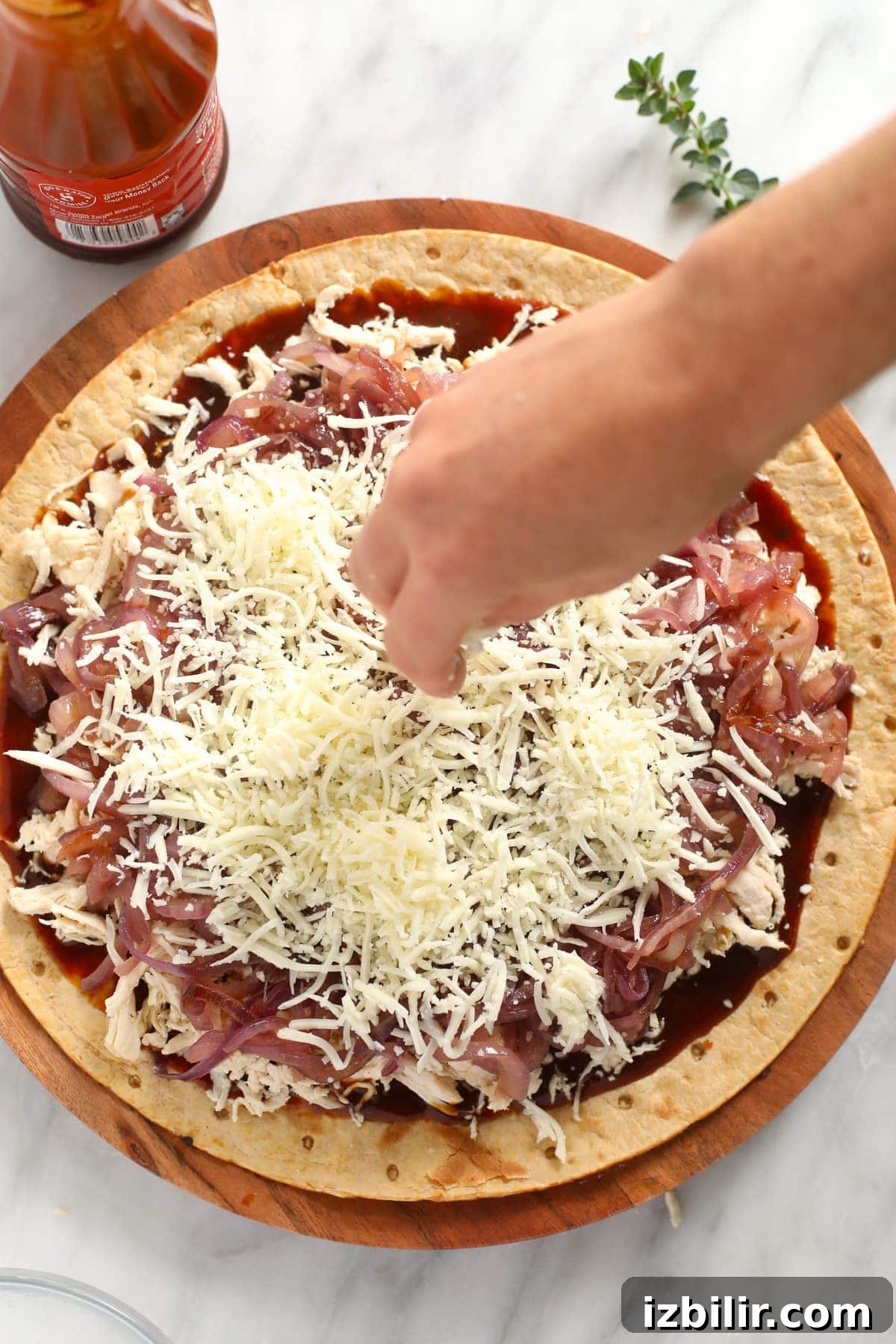 sprinkling cheese on pizza