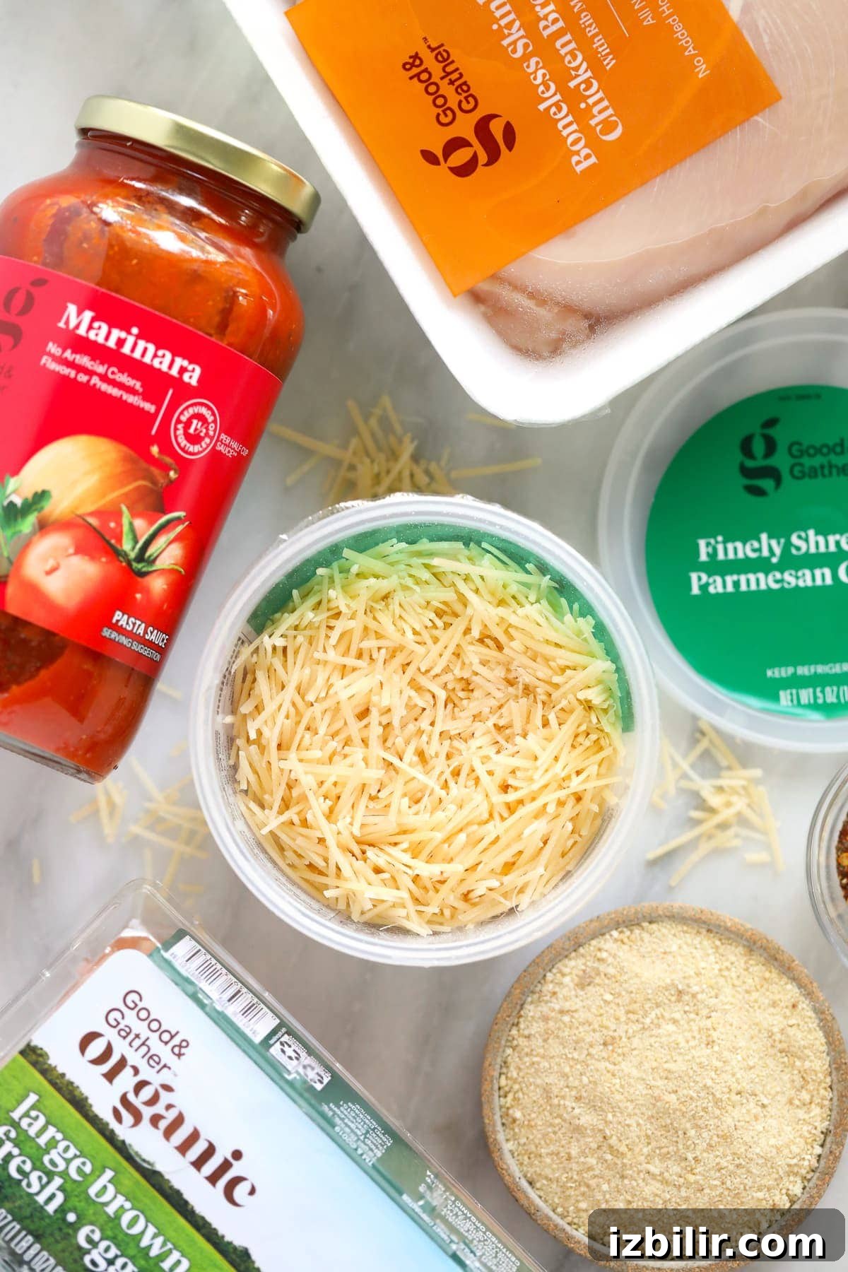 chicken parm ingredients - parmesan cheese, marinara sauce, and chicken breast