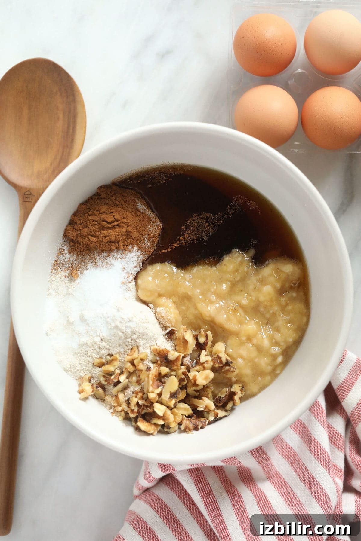 All of the ingredients for the banana nut muffins in a bowl.