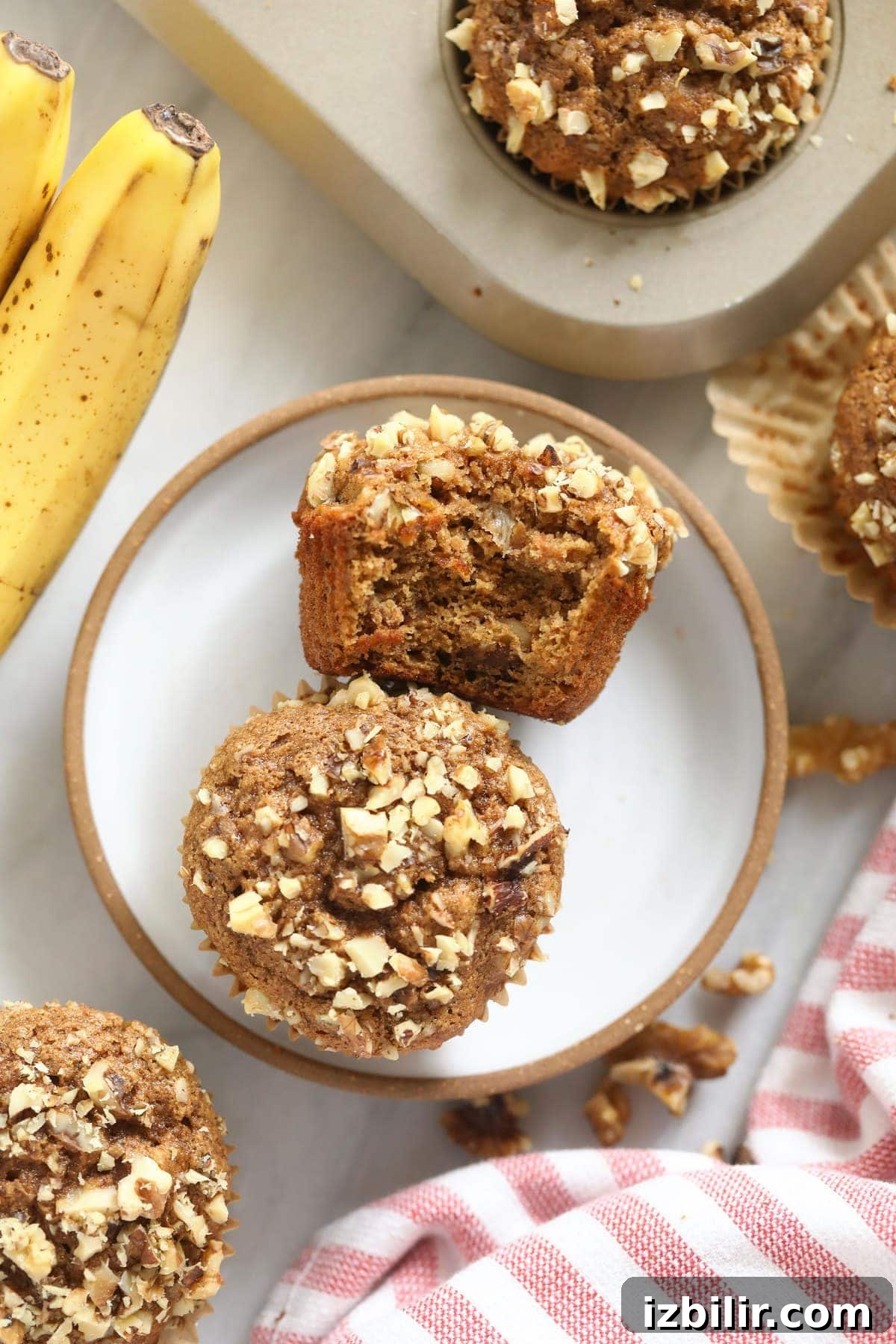Two banana nut muffins on a plate.