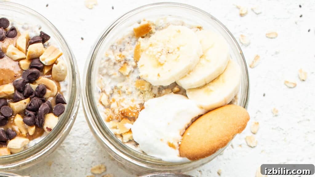 Two jars of oatmeal with bananas, nuts and whipped cream.