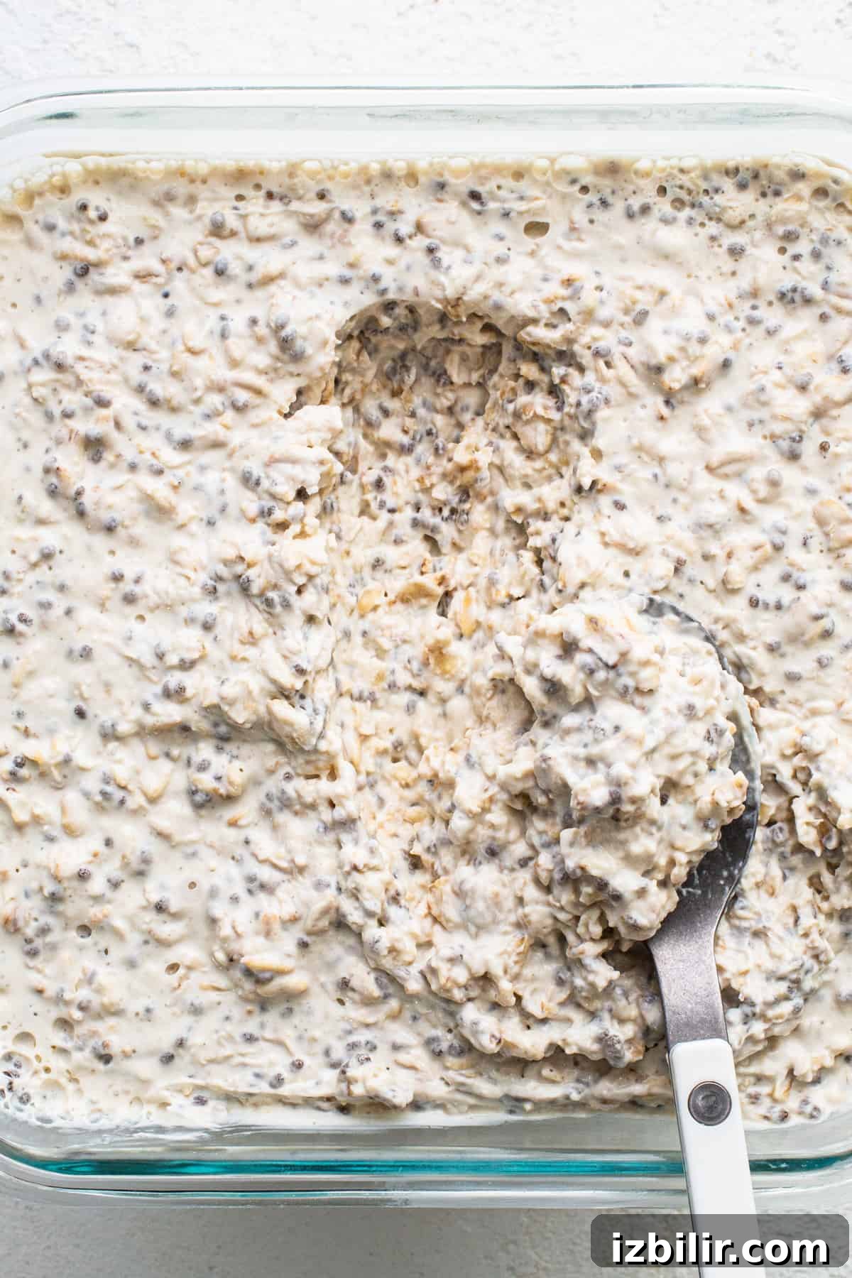A bowl of oatmeal with a spoon in it.