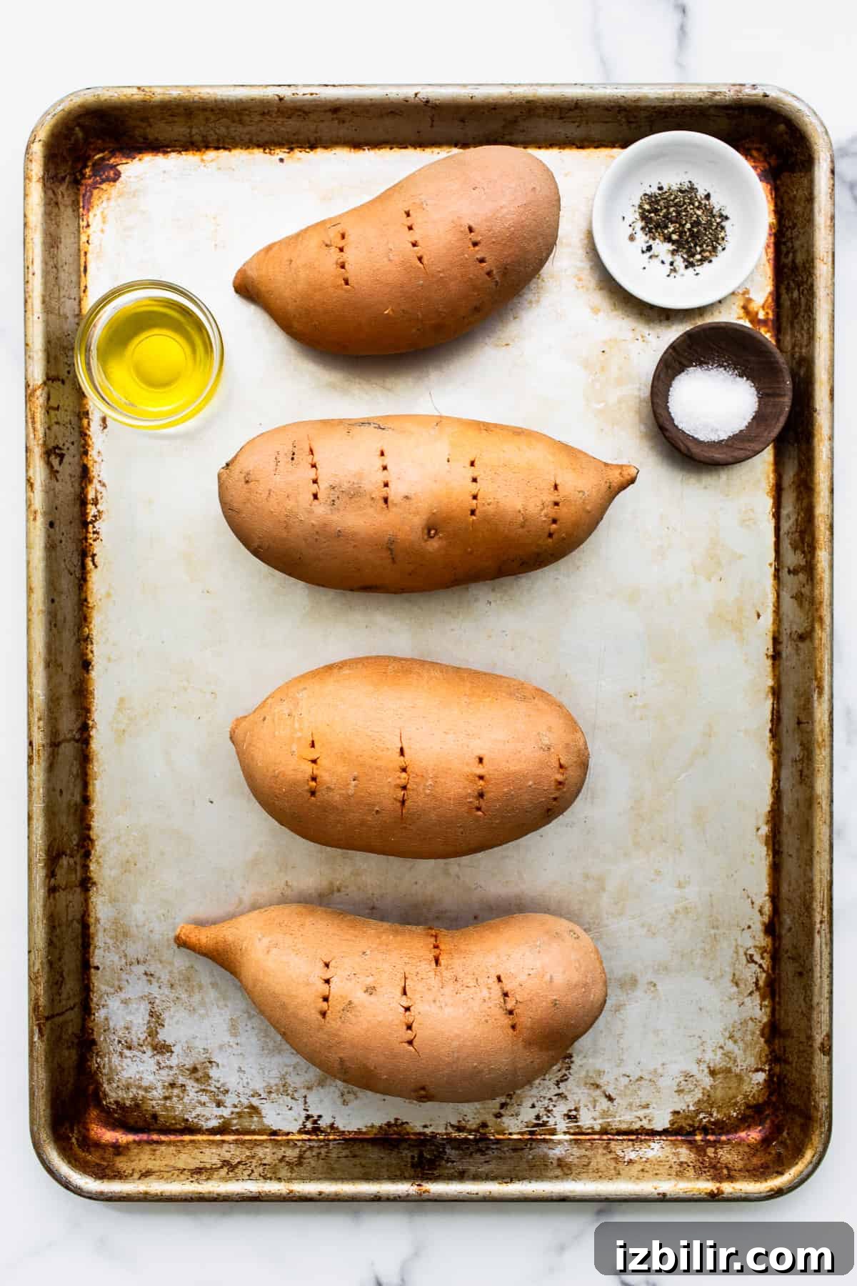 Sweet potatoes on a baking sheet. Sweet potatoes on a baking sheet.