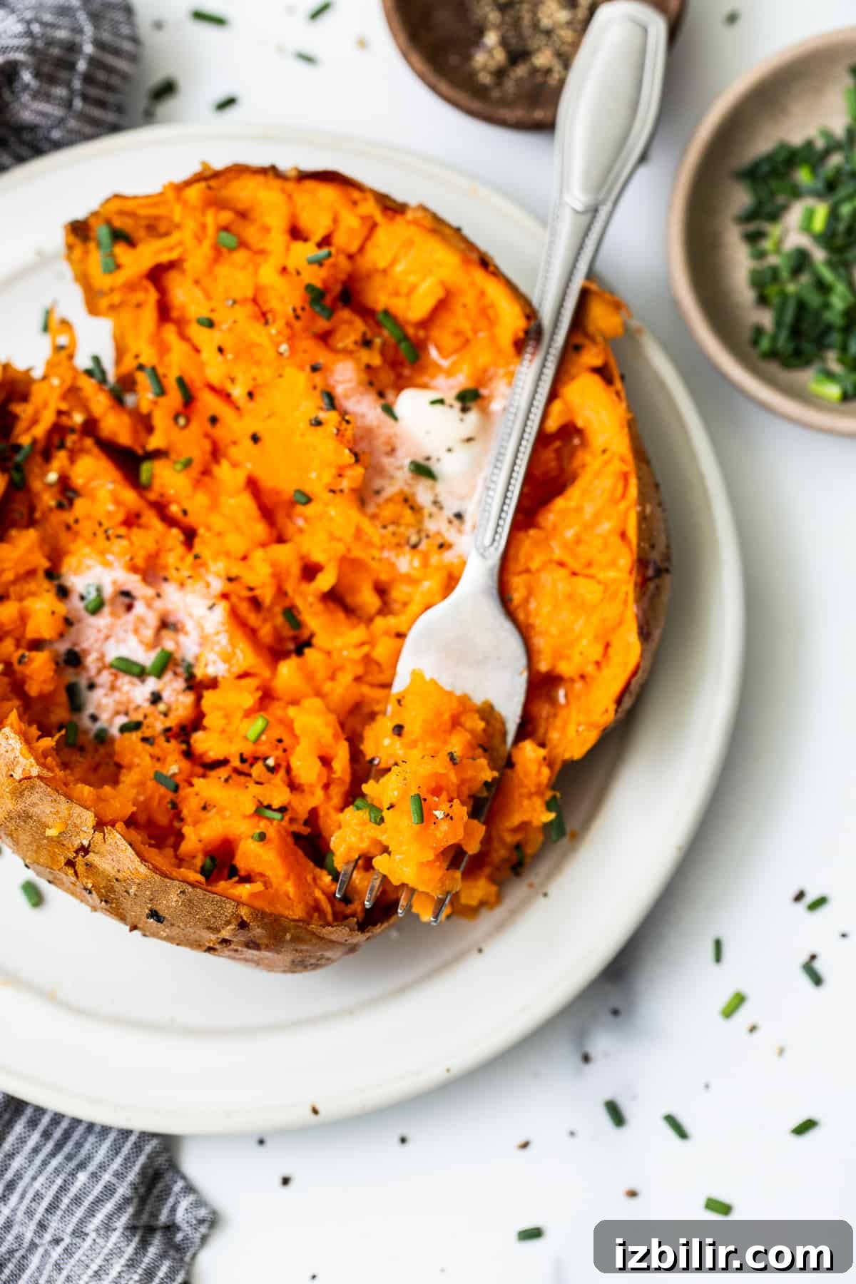 Baked sweet potato on a fork. Baked sweet potato on a fork.