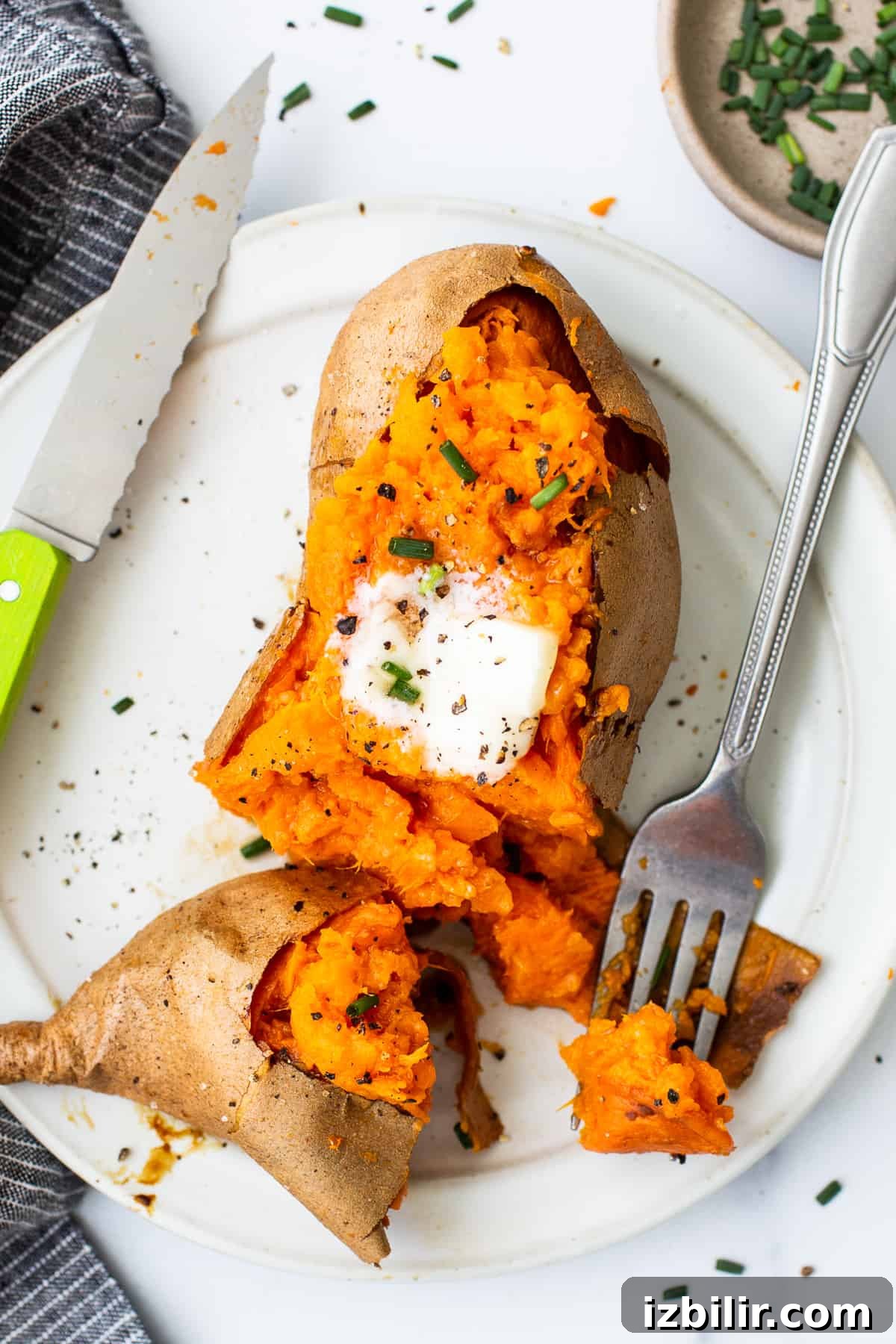 Baked sweet potato on a plate with a fork. Baked sweet potato on a plate with a fork.