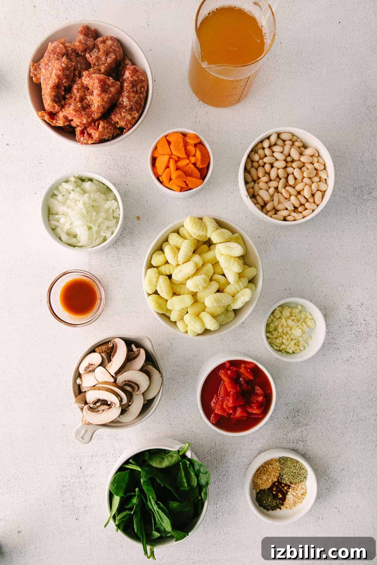 ingredients for sausage gnocchi soup in little bowls ready to be mixed together