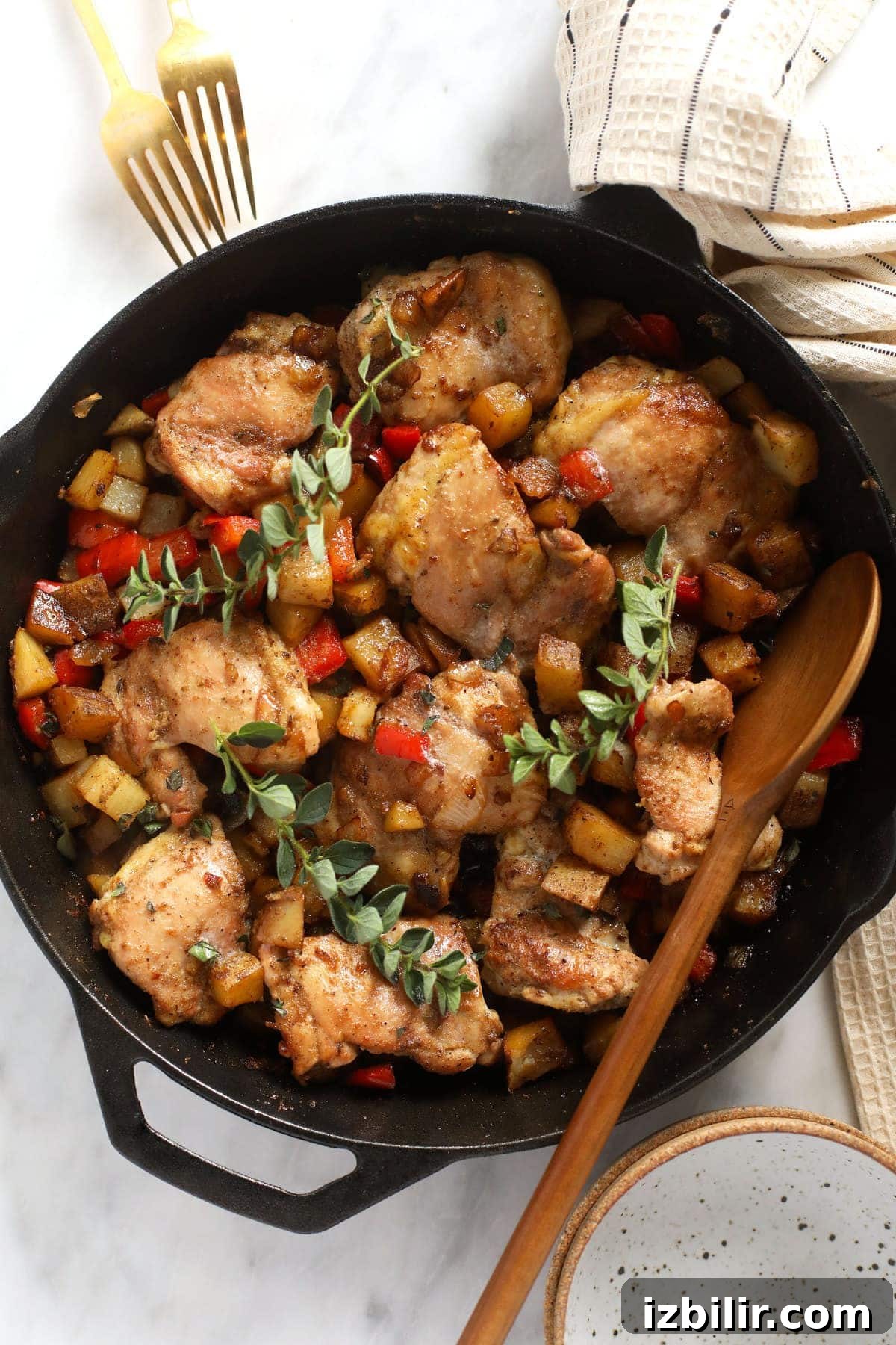 skillet chicken and potatoes in a cast iron skillet