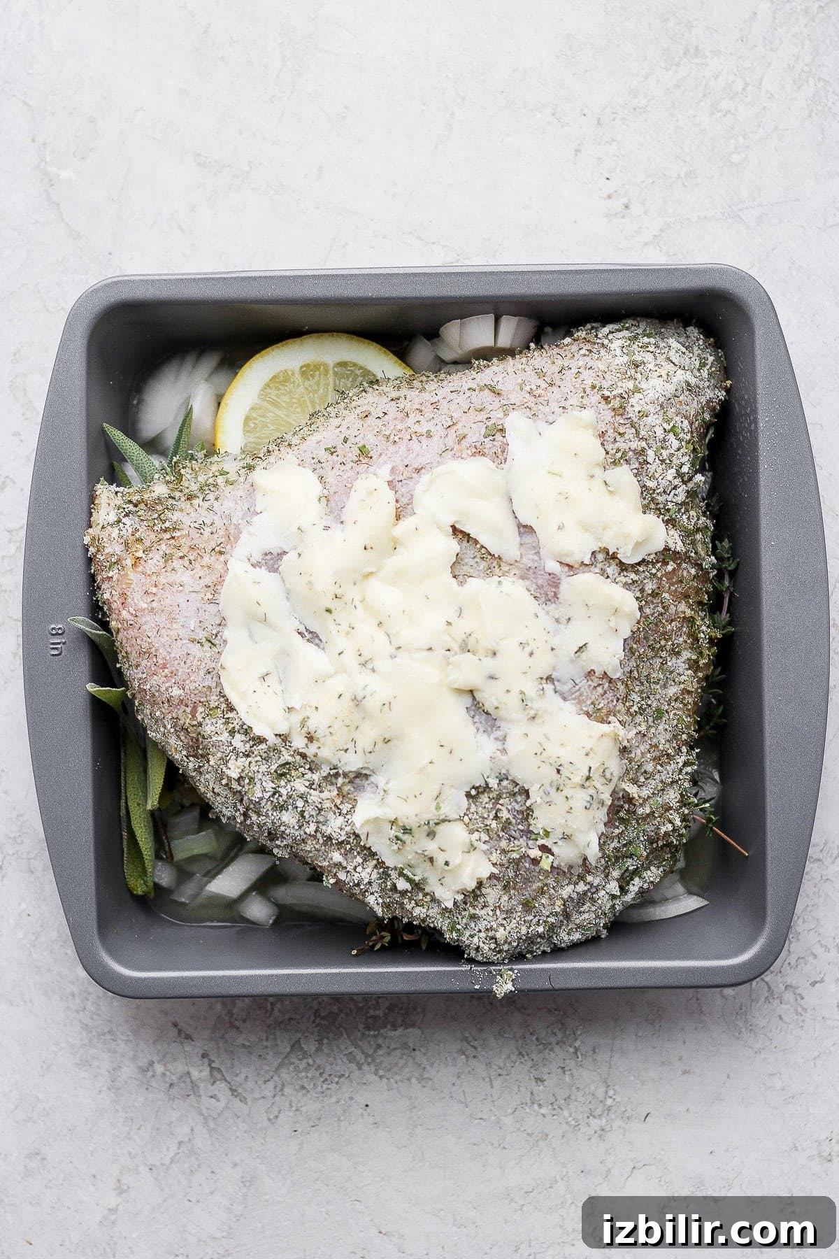 Herb Ranch Roasted Turkey Breast Recipe 5 Butter, herbs, and a turkey breast in a baking dish.