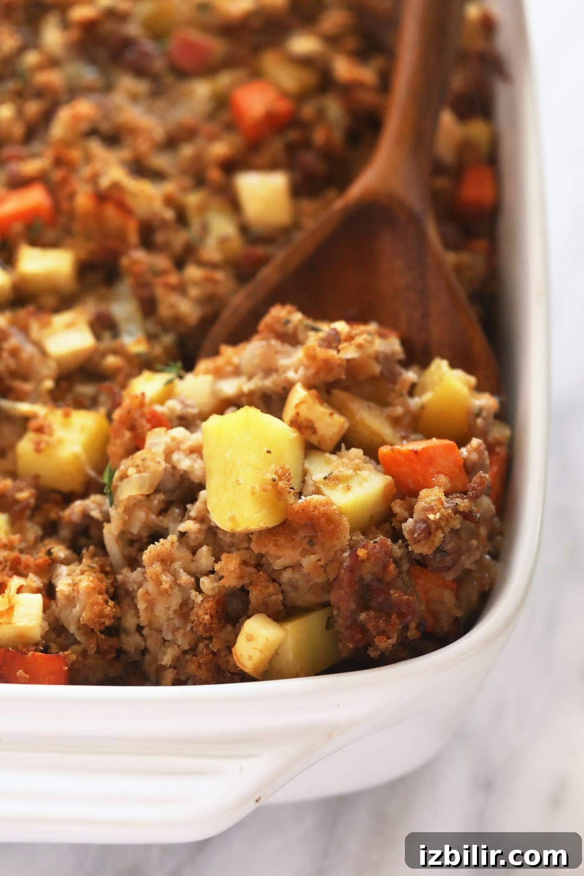 Ready to serve sausage stuffing sausage stuffing on a wooden spoon ready to be served