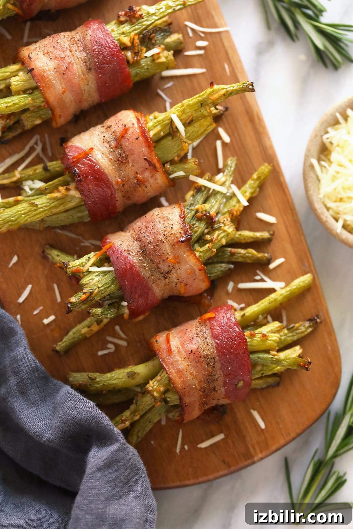 bacon wrapped green beans served on a wooden platter