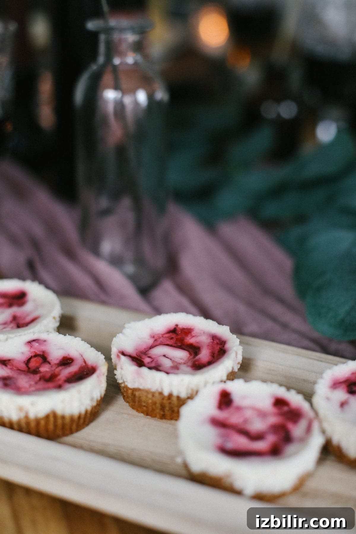 The most delicious, guilt-free dessert recipe made with a graham cracker crust, Greek yogurt cheesecake filling, and a cranberry sauce swirl! mini cheesecakes
