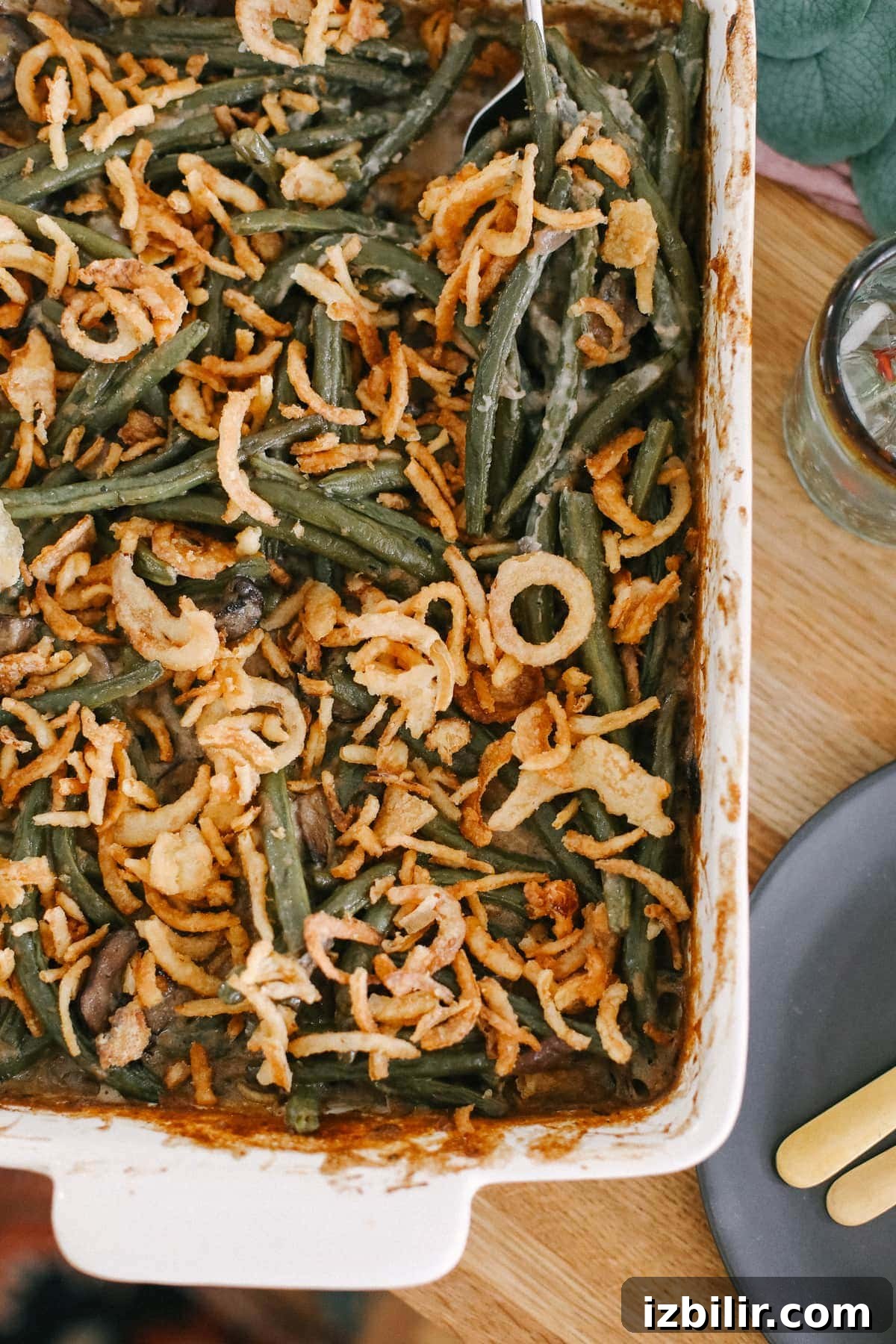Say hello to the most delicious vegan green bean casserole recipe on the internet. This vegan green bean casserole is made with fresh green beans, mushrooms, a vegan roux, and fried onions! green bean casserole on table