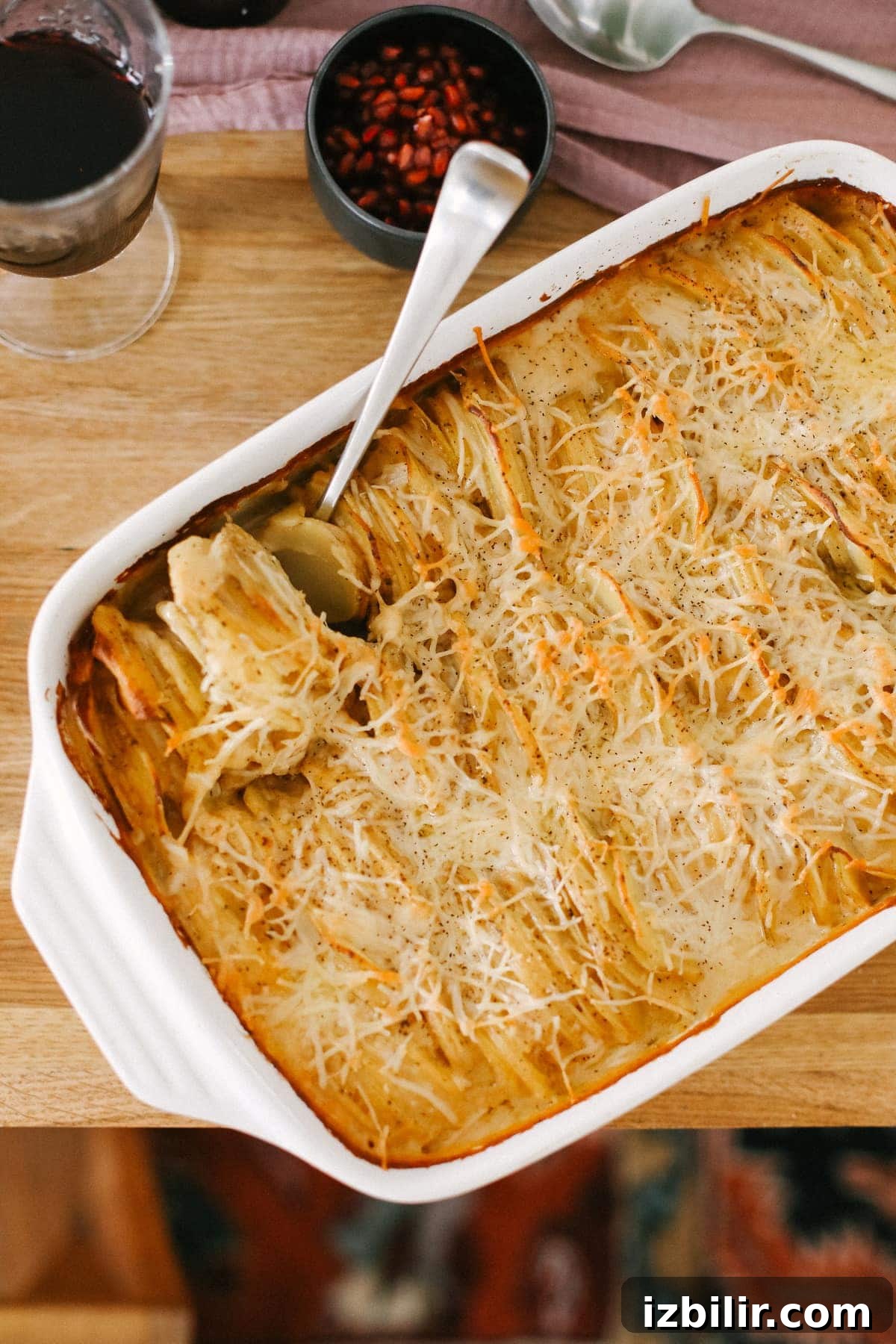 These cheesy scalloped potatoes are rich, creamy, and easy to make! They are made with a healthier cheese sauce made with Greek yogurt, thinly sliced potatoes, and fresh thyme. You'll never use another cheesy potato recipe again. scalloped potatoes on table