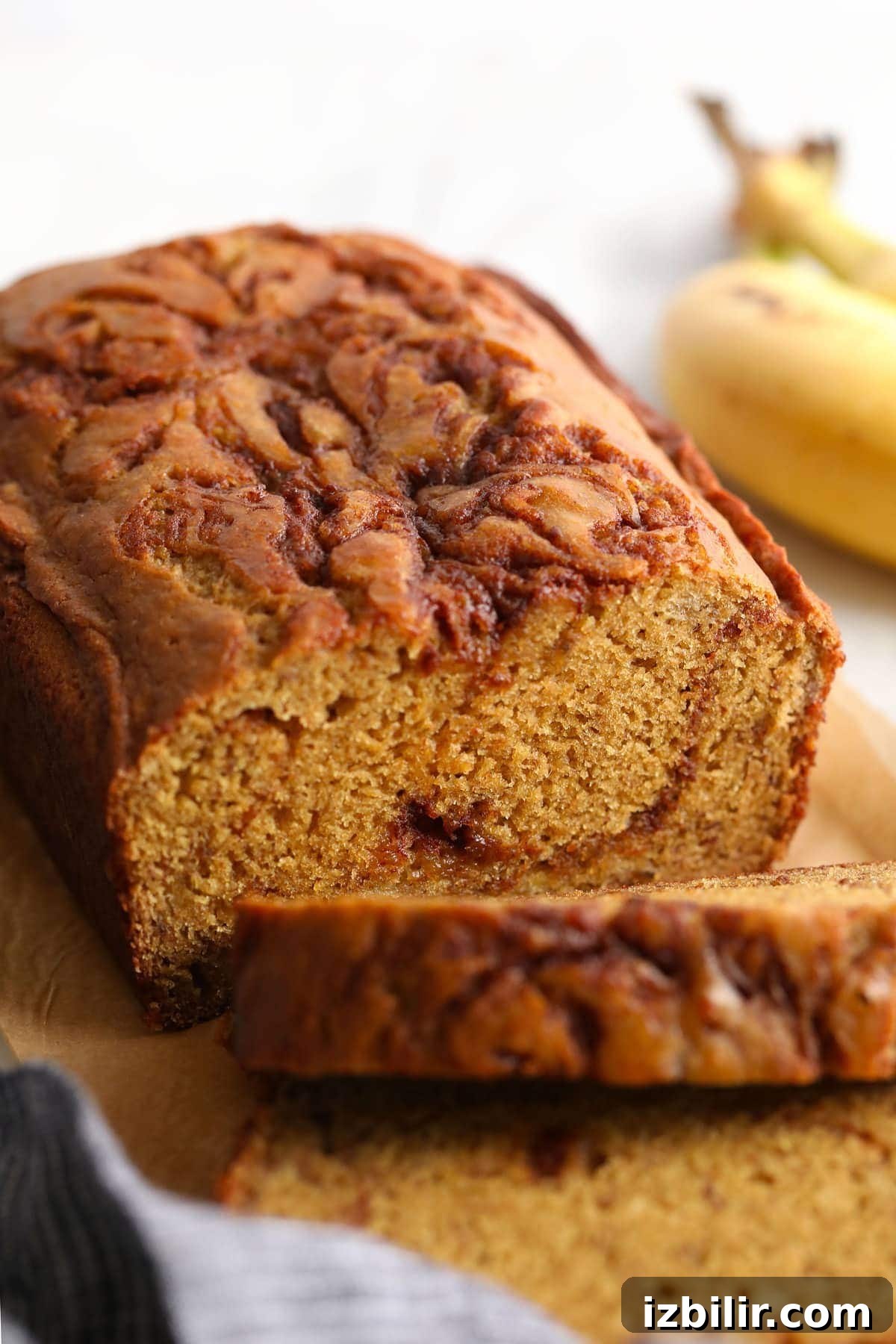 Cinnamon swirl banana bread cut into slices.