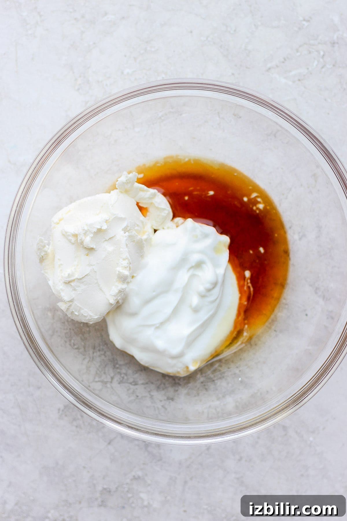 This Greek yogurt cream cheese frosting is the most delicious healthy cream cheese frosting we've ever had! Cream cheese frosting ingredients in a bowl.