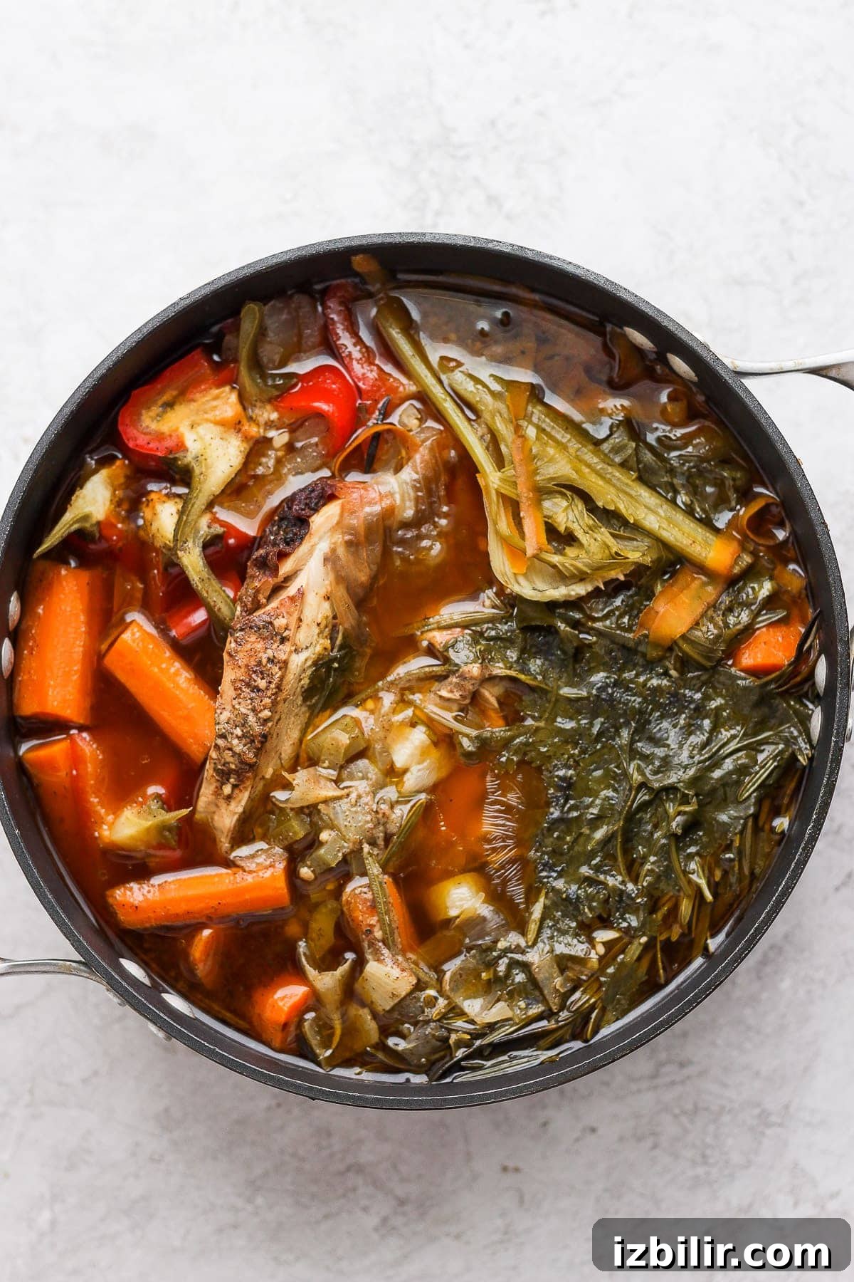 A pot of chicken and vegetables after simmering all day.