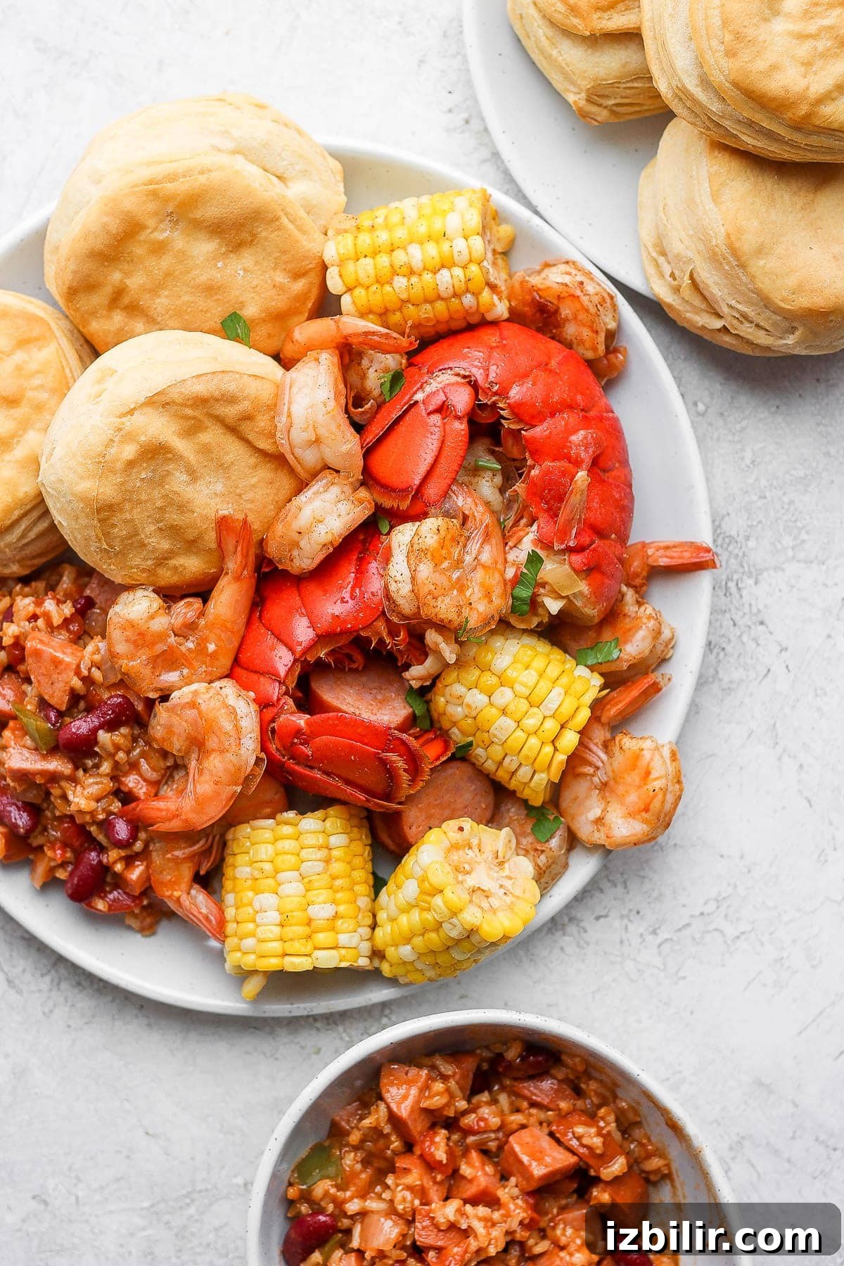 easy seafood boil on a plate with rice and beans and biscuits