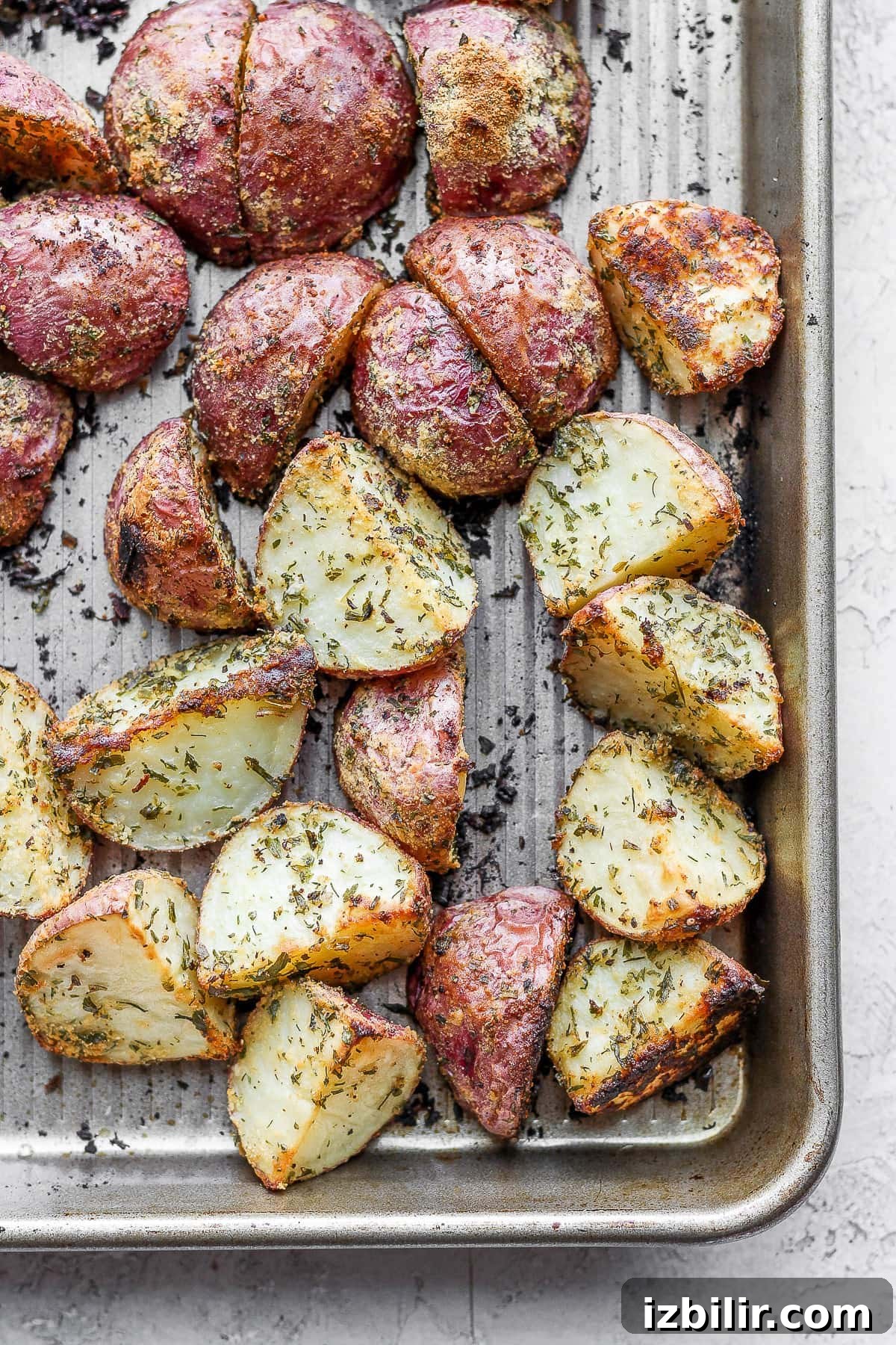 These Ranch Roasted Potatoes are flavor-packed and deliciously crispy! Whip up a batch for the most flavorful side dish. roasted red potatoes on a baking sheet looking crispy and delicious